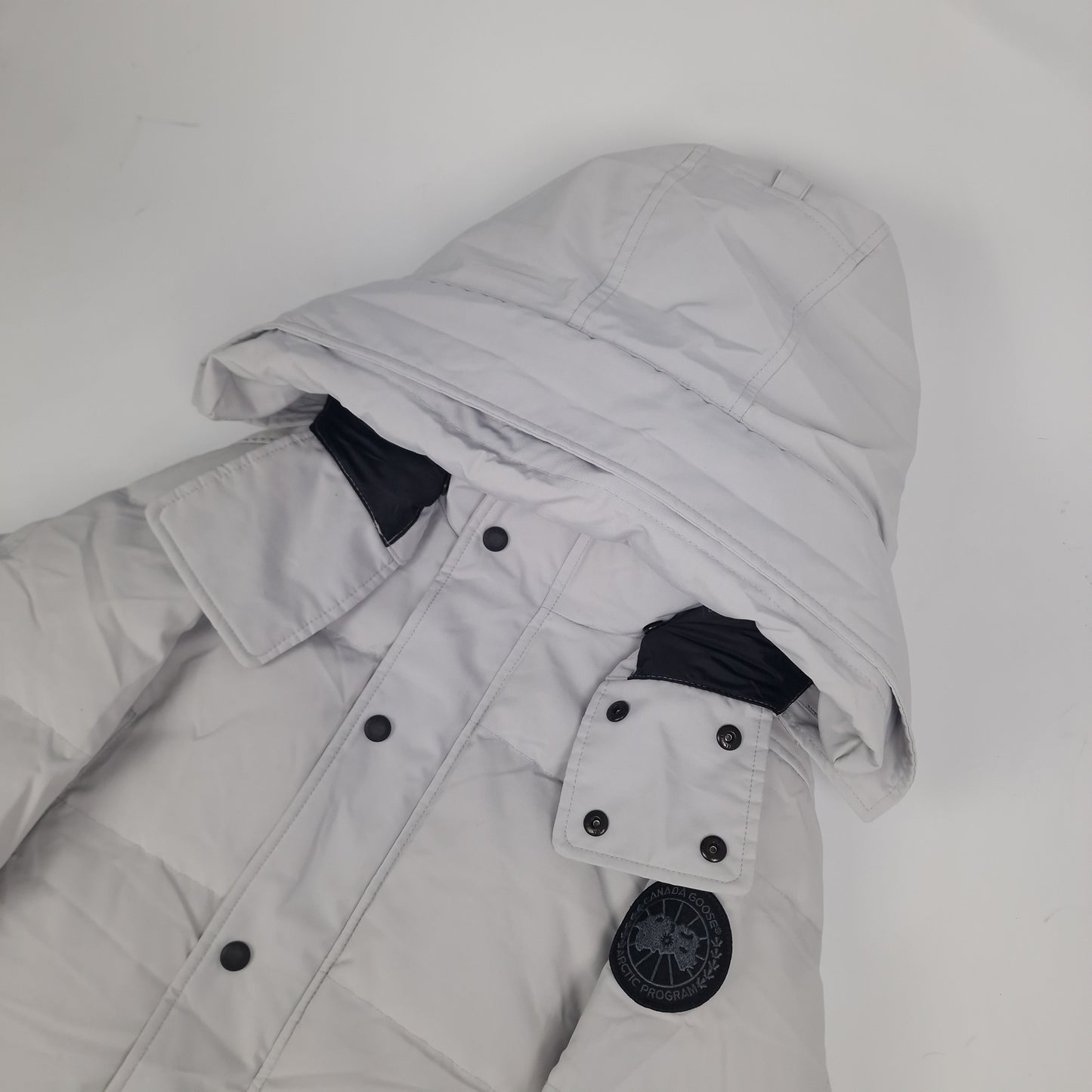 Close-up side view of Canada Goose Wyndham Parka Black Label showing authentic coyote fur hood trim and iconic Canada Goose Arctic Program badge, Silverbirch colorway 3808MB Medium
