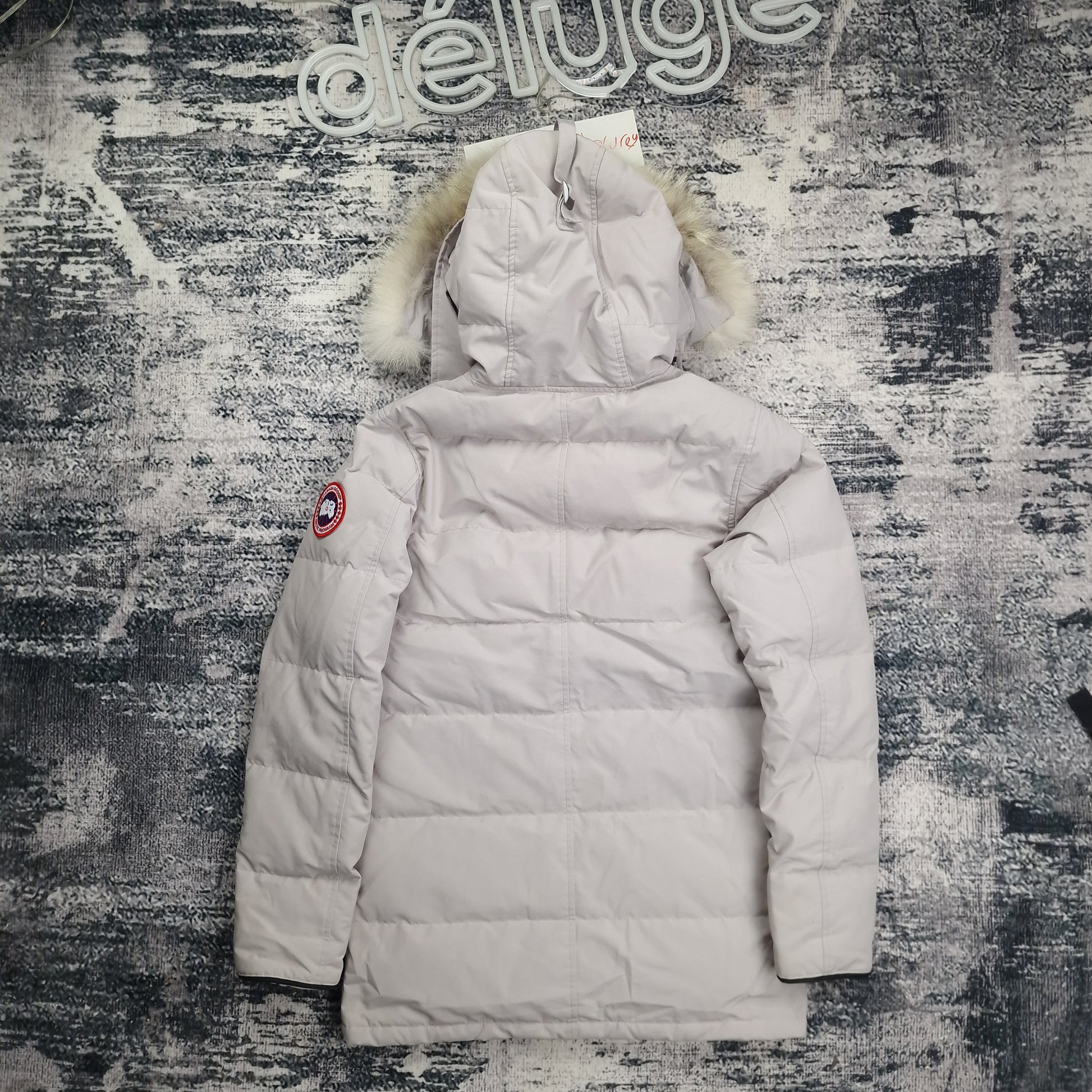 Back flat lay of Canada Goose Carson Parka 3805M men's small in limestone with coyote fur-trimmed hood and thigh-length design