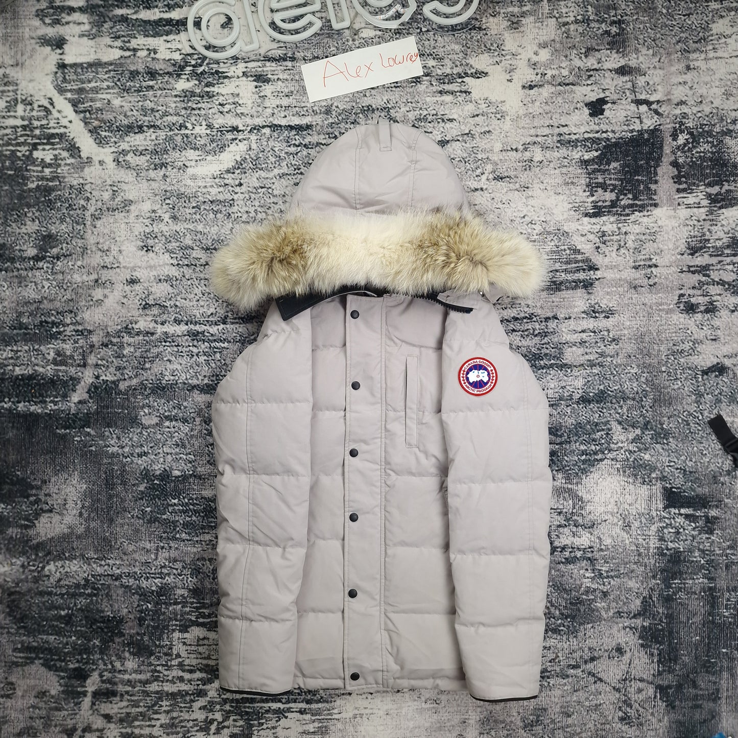 Front flat lay of Canada Goose Carson Parka 3805M men's small featuring coyote fur hood, chest pockets, and Arctic badge