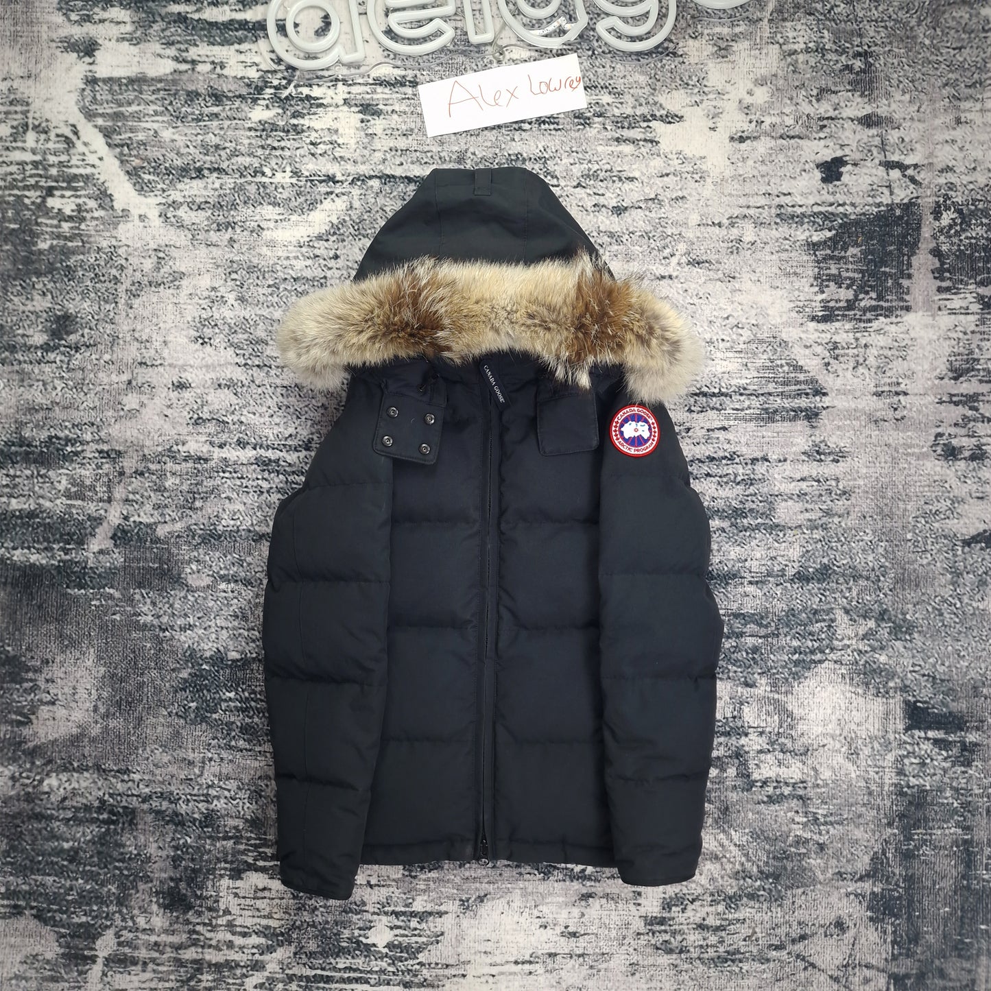 Front flat lay of authentic black Canada Goose Chelsea Parka women's small showing fur hood, chest pockets, and full-zip closure