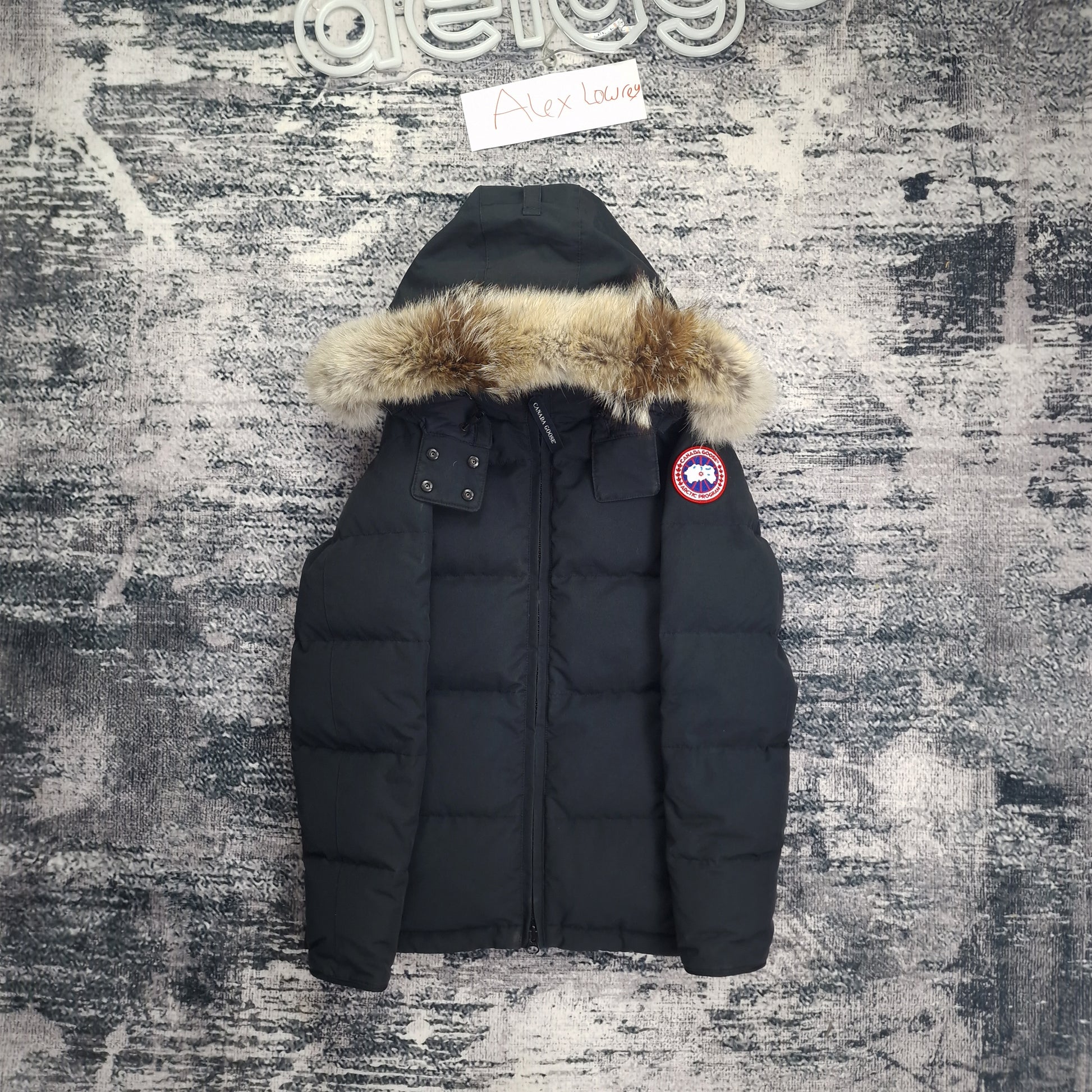 Front flat lay of authentic black Canada Goose Chelsea Parka women's small showing fur hood, chest pockets, and full-zip closure