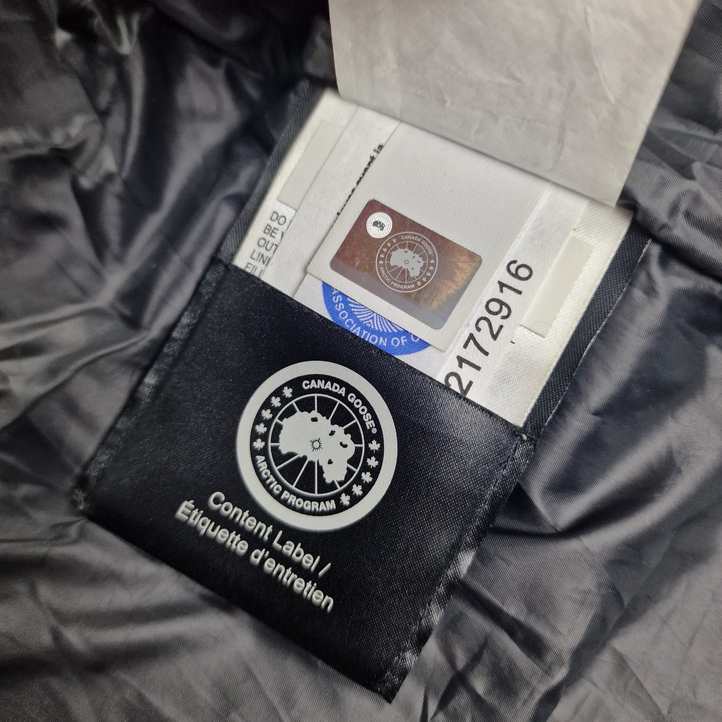Authentic Canada Goose hologram security tag with serial number showing genuine Macmillan Black Label Parka verification