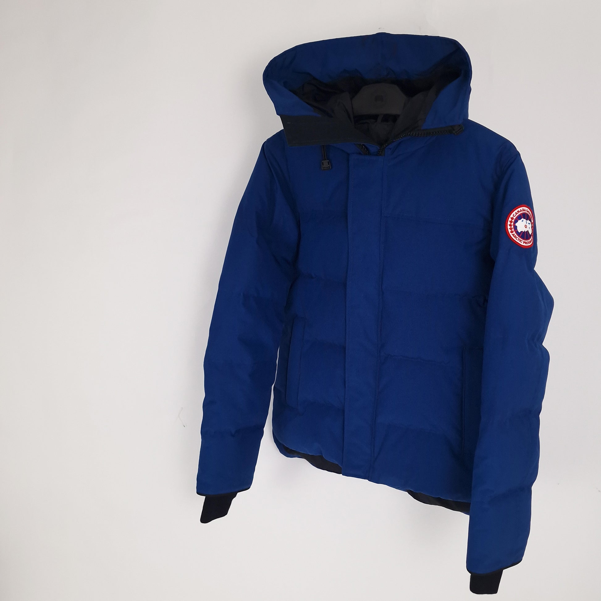 Angled detail shot of Northern Night blue Canada Goose Macmillan Parka men's medium showing hood construction and sleeve badge