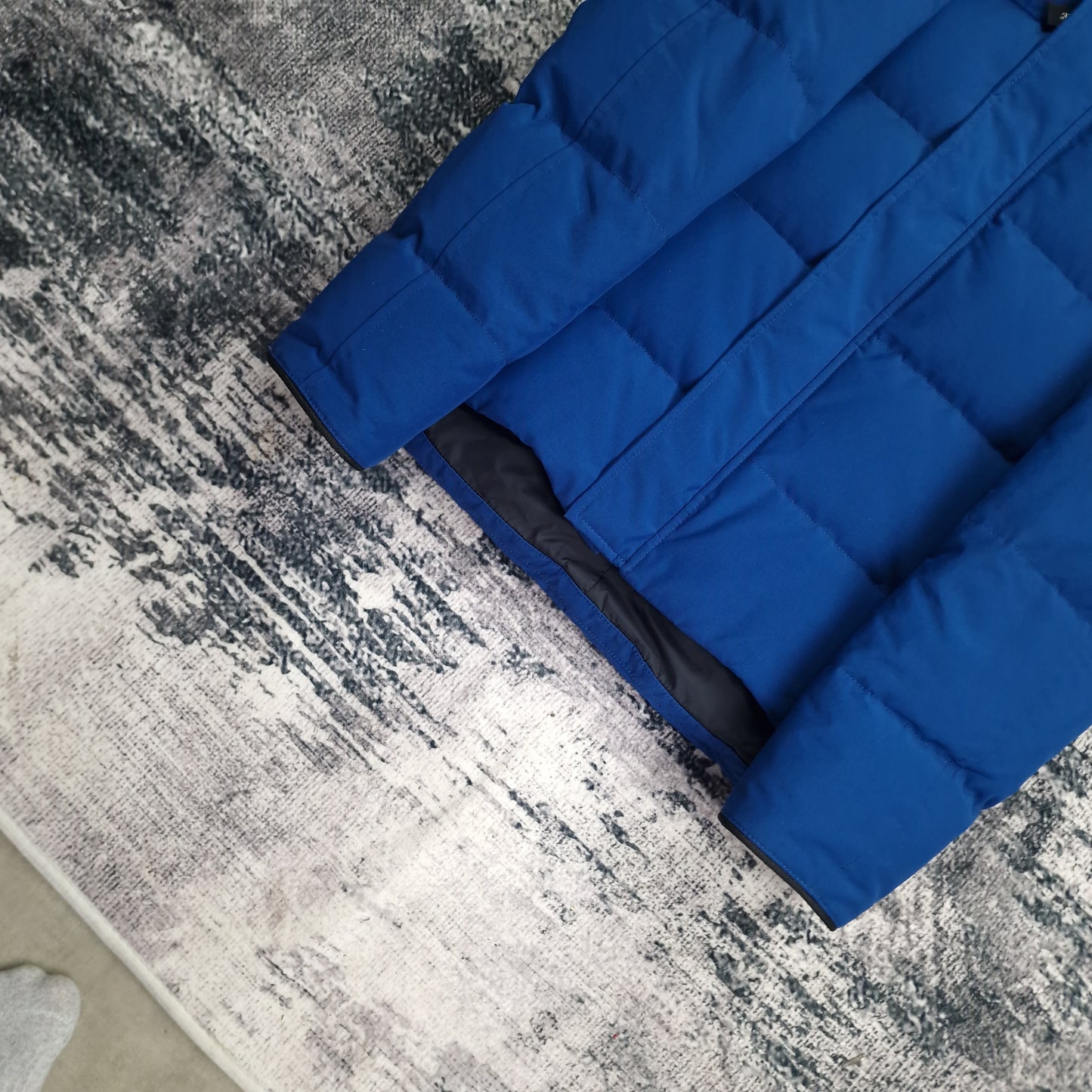 Interior lining detail of Northern Night blue Canada Goose Macmillan Parka men's medium showing quilted down construction and black inner fabric