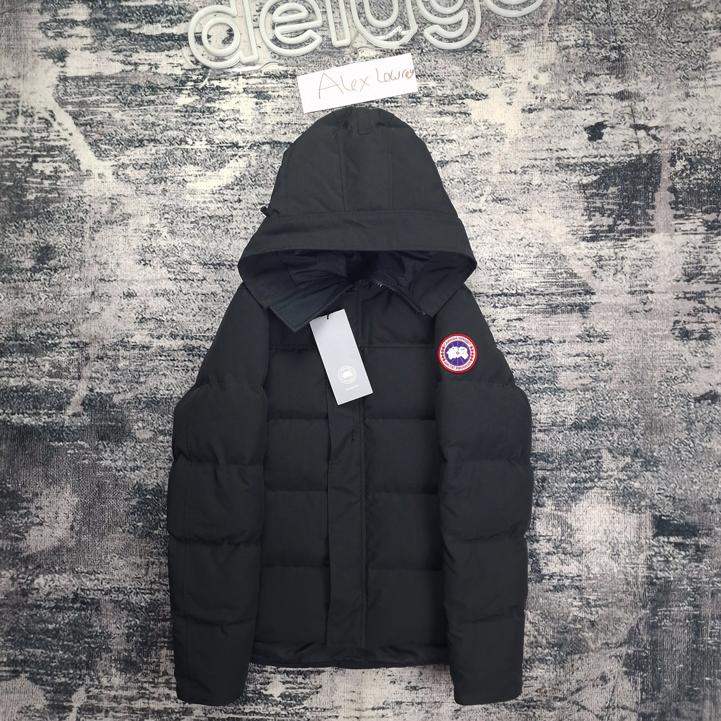 Front flat lay of black Canada Goose Macmillan Parka 3804MA men's large with authentic tags and Arctic disc badge