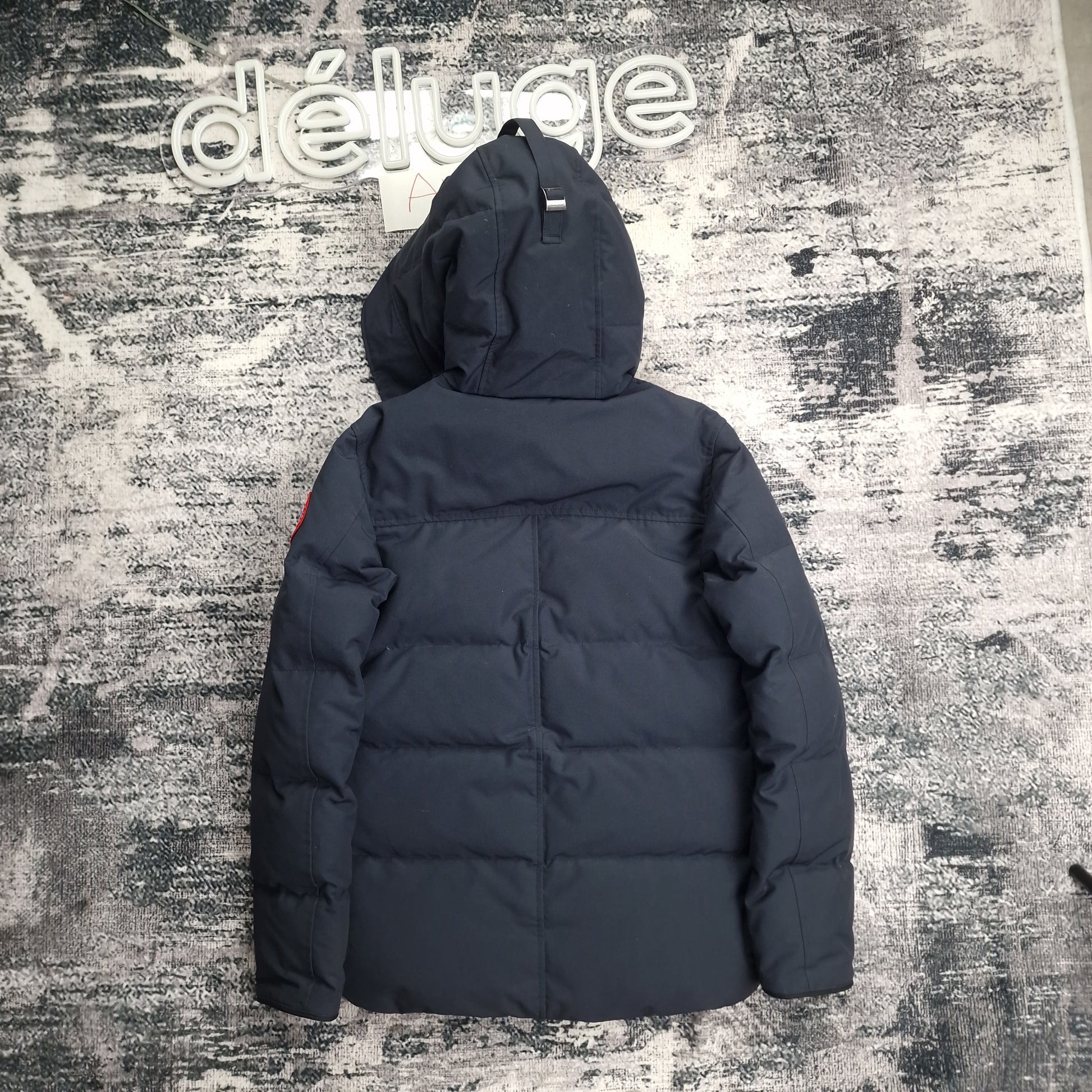 Back flat lay of Canada Goose Macmillan Parka 3804M in navy men's size XS showing quilted down construction and hood