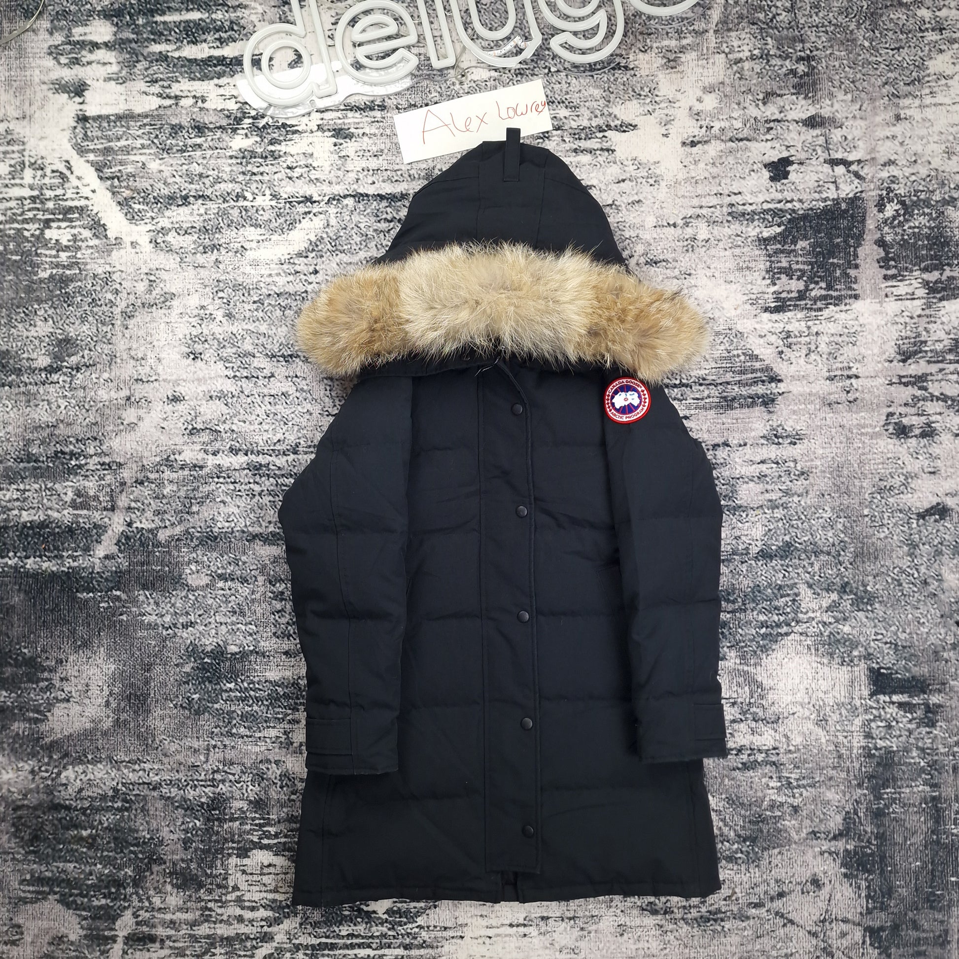 Front flat lay of Canada Goose Shelburne Parka 3802LA women's small in Heritage Black with fur-trimmed hood and Arctic disc