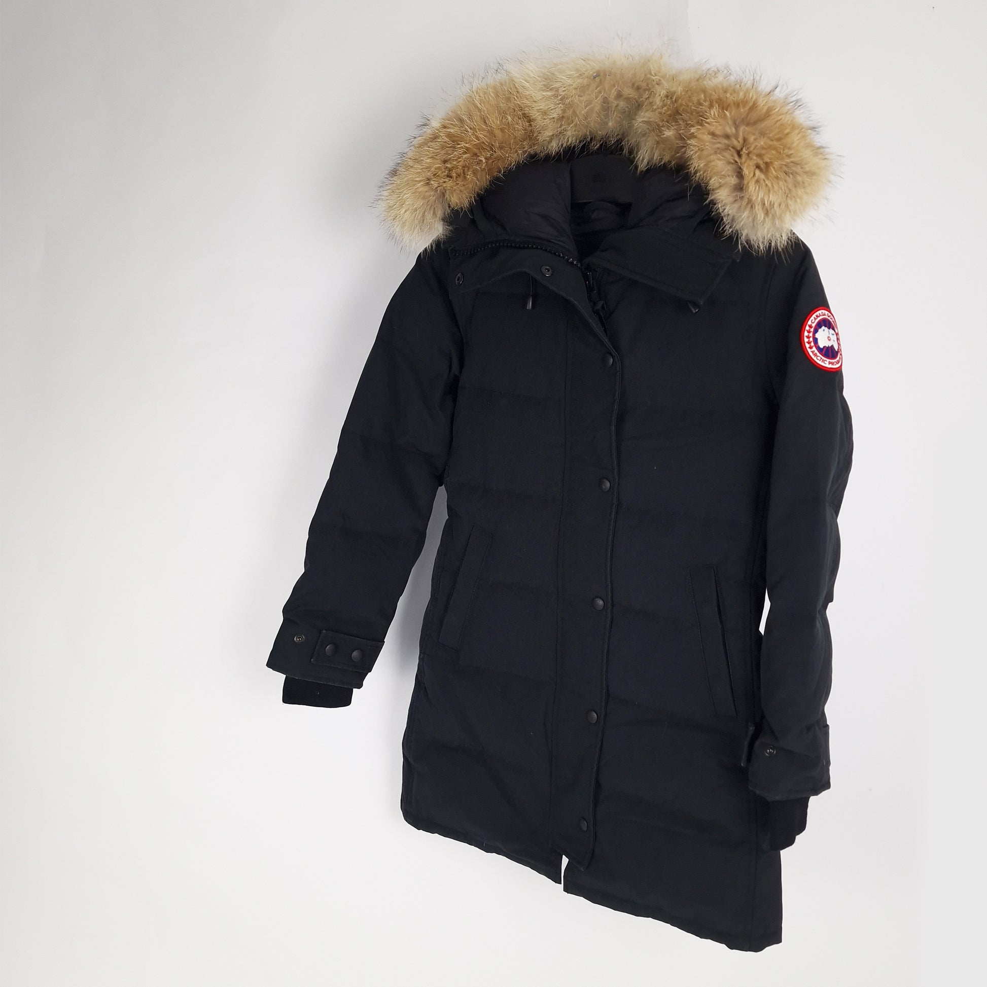 Angled view of Heritage Black Canada Goose Shelburne Parka 3802LA women's small displaying fur hood and elegant knee-length design