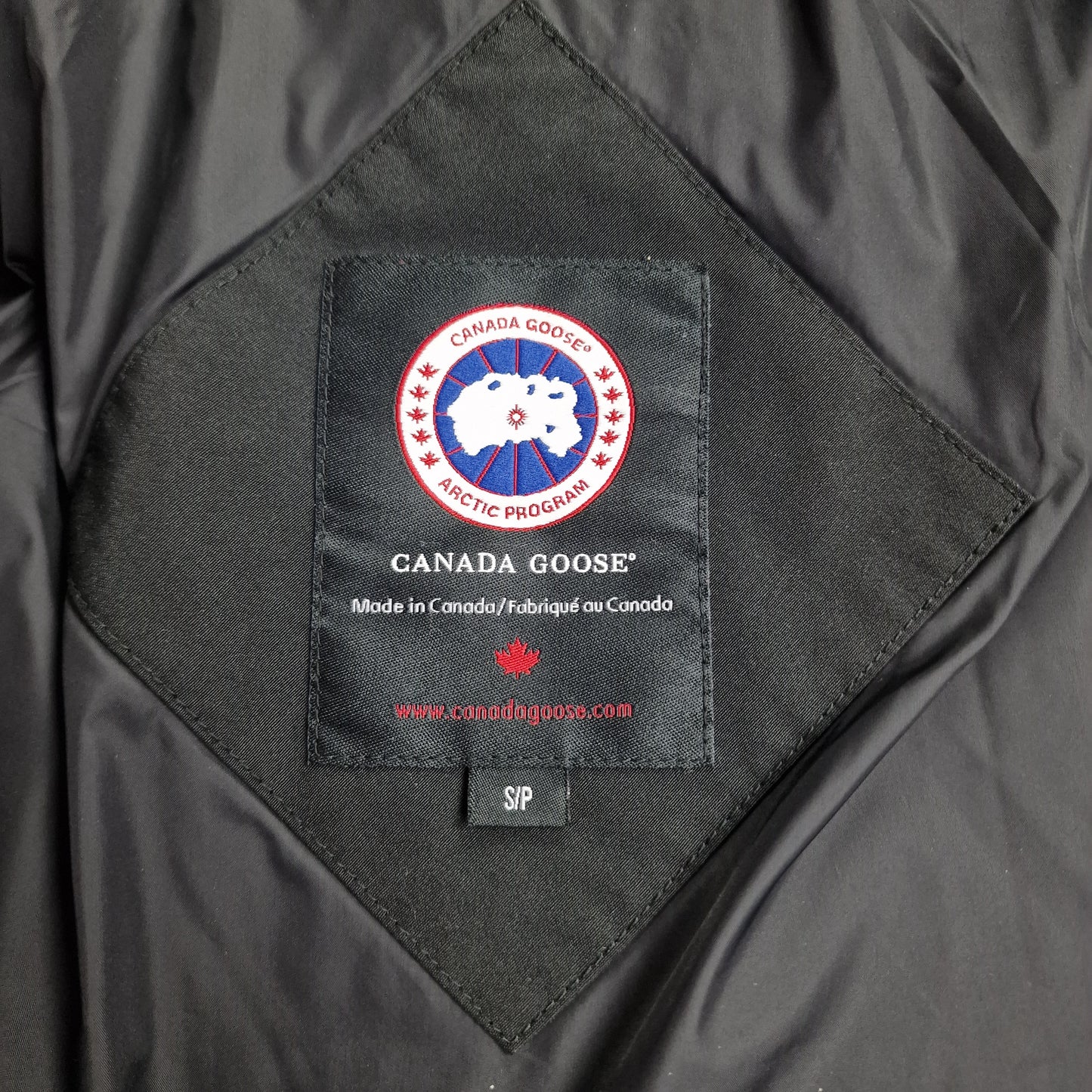Canada Goose Portland Parka Neck Tag Close-Up Showing Size Label