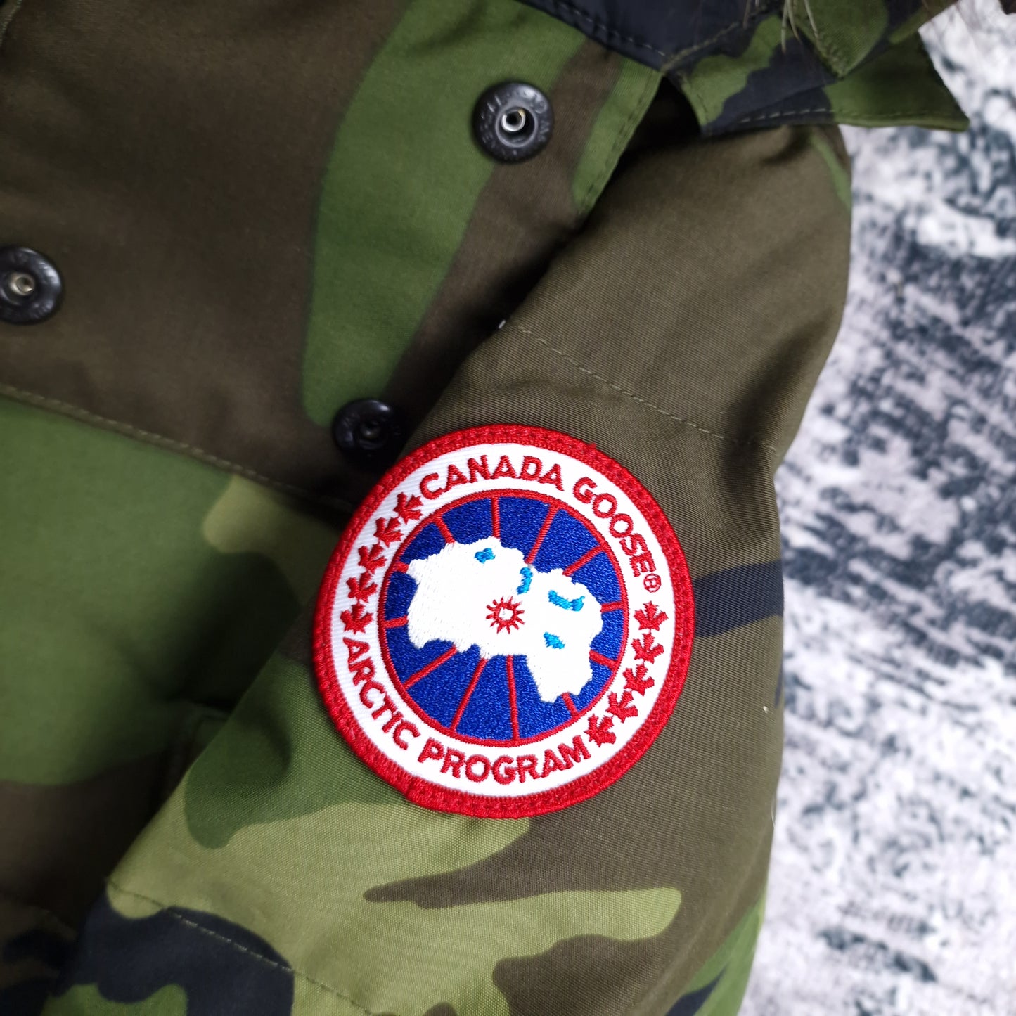 Canada Goose Badge Close-Up Detail on Wyndham Parka Heritage Camo Men's