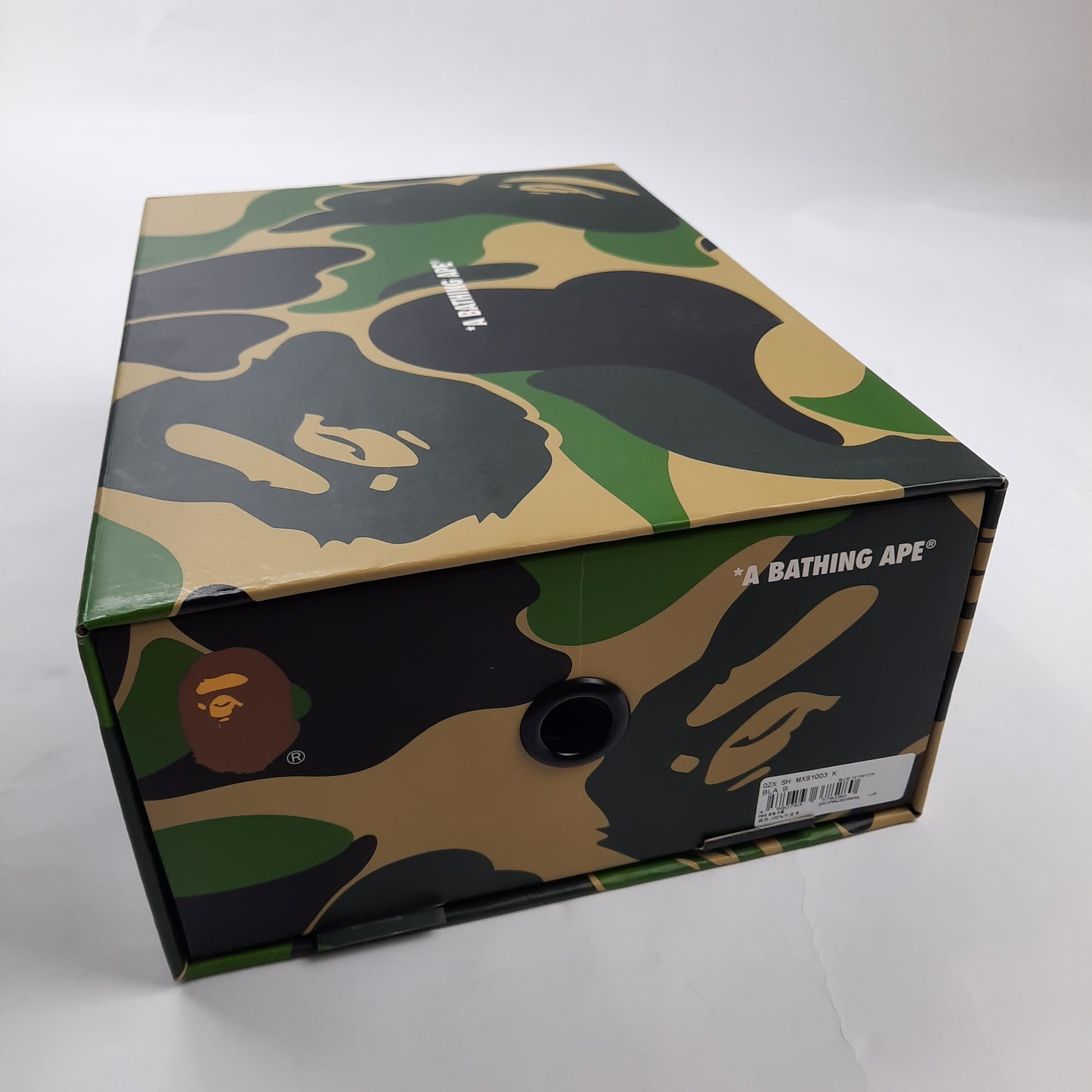 A Bathing Ape camouflage shoe box with BAPE ape head logo, authentic Bapesta sneaker packaging UK size 8