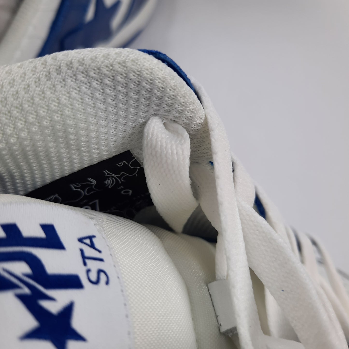 Inside label of A Bathing Ape Bapesta showing UK size 8 and authentic BAPE branding details