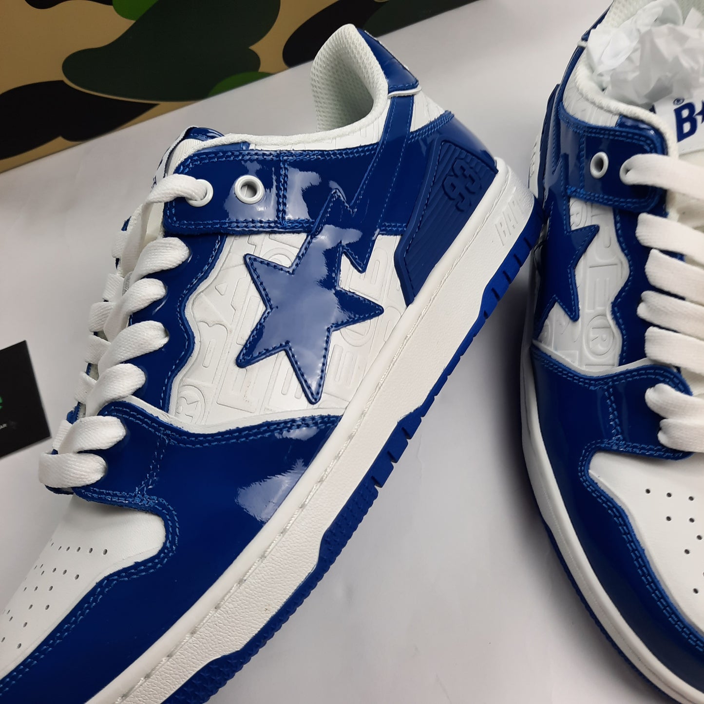 Close-up of signature BAPE star logo on Bapesta sneakers, blue patent leather with white star design