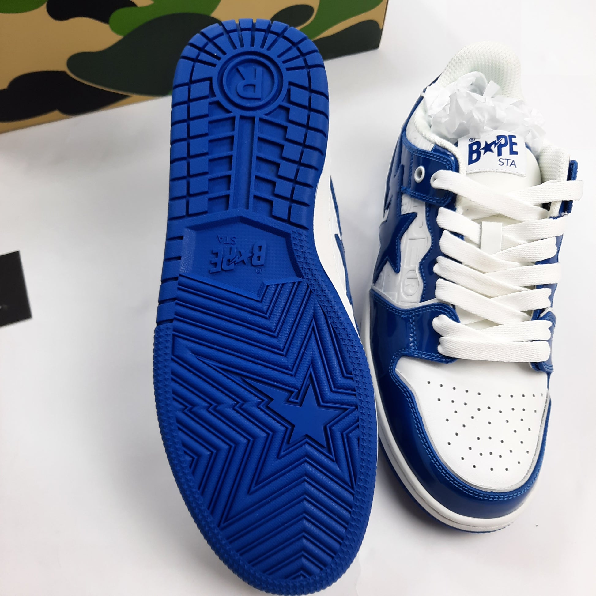 Bottom sole view of BAPE Bapesta showing blue rubber outsole with star pattern and BAPE STA branding