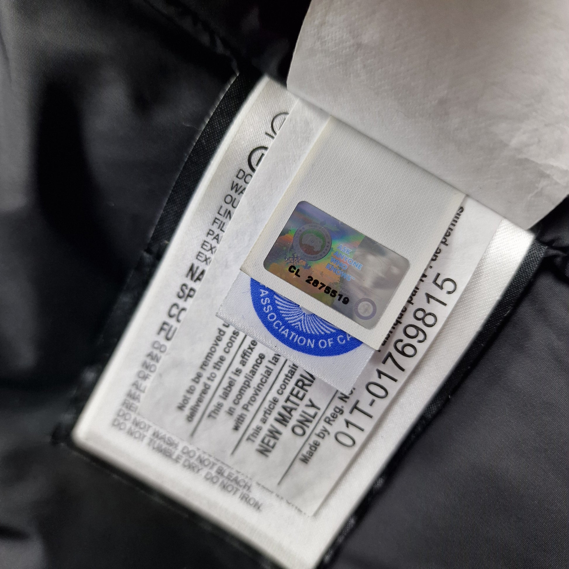 Close-up of Canada Goose authenticity hologram on Carson Parka 3805M, verification label confirming genuine men's Small Graphite grey luxury winter coat
