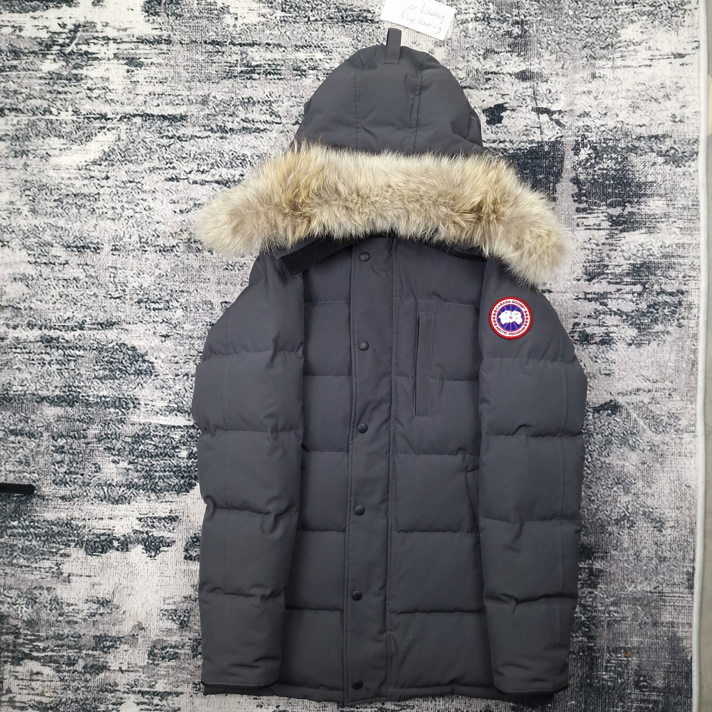 Front view of men's Canada Goose Carson Parka 3805M Small in Graphite grey with coyote fur-trimmed hood, luxury winter coat photographed on styled background