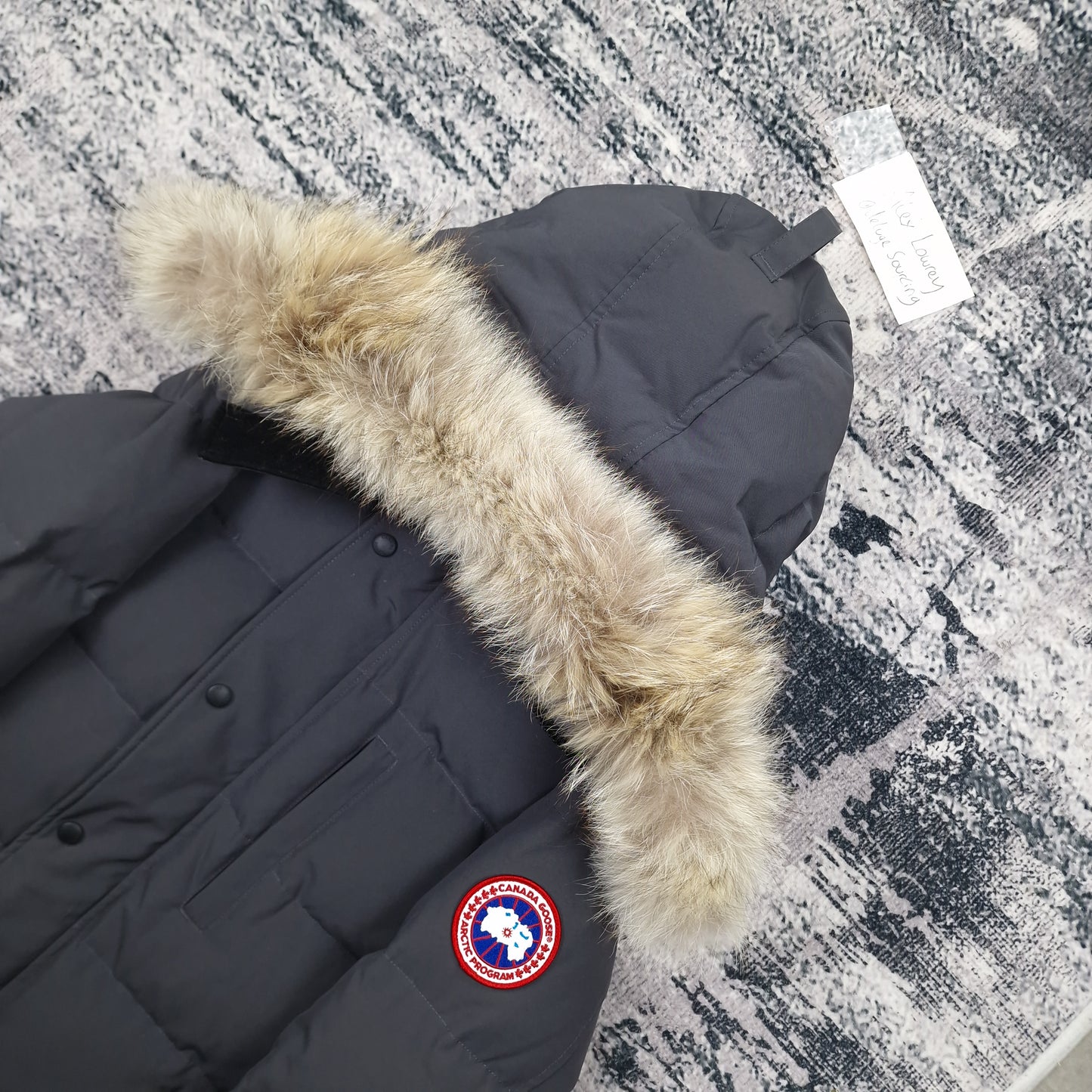 Close-up side view of Canada Goose Carson Parka showing authentic coyote fur hood trim and iconic Canada Goose Arctic Program badge, Graphite grey colorway 3805M Small