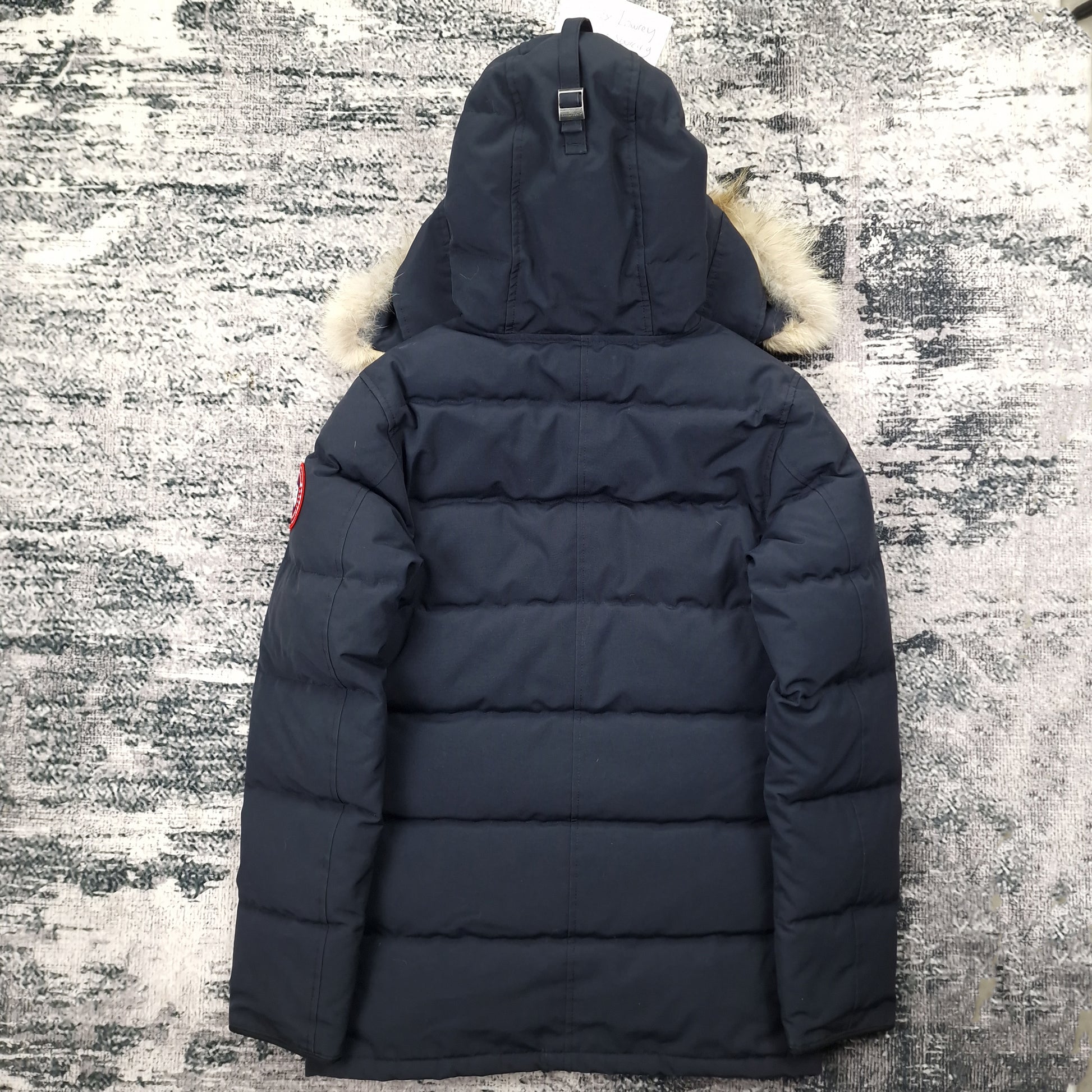 Back view of men's Canada Goose Carson Parka 3805MA Small in navy featuring Arctic Program patch, hip-length winter coat photographed on styled background