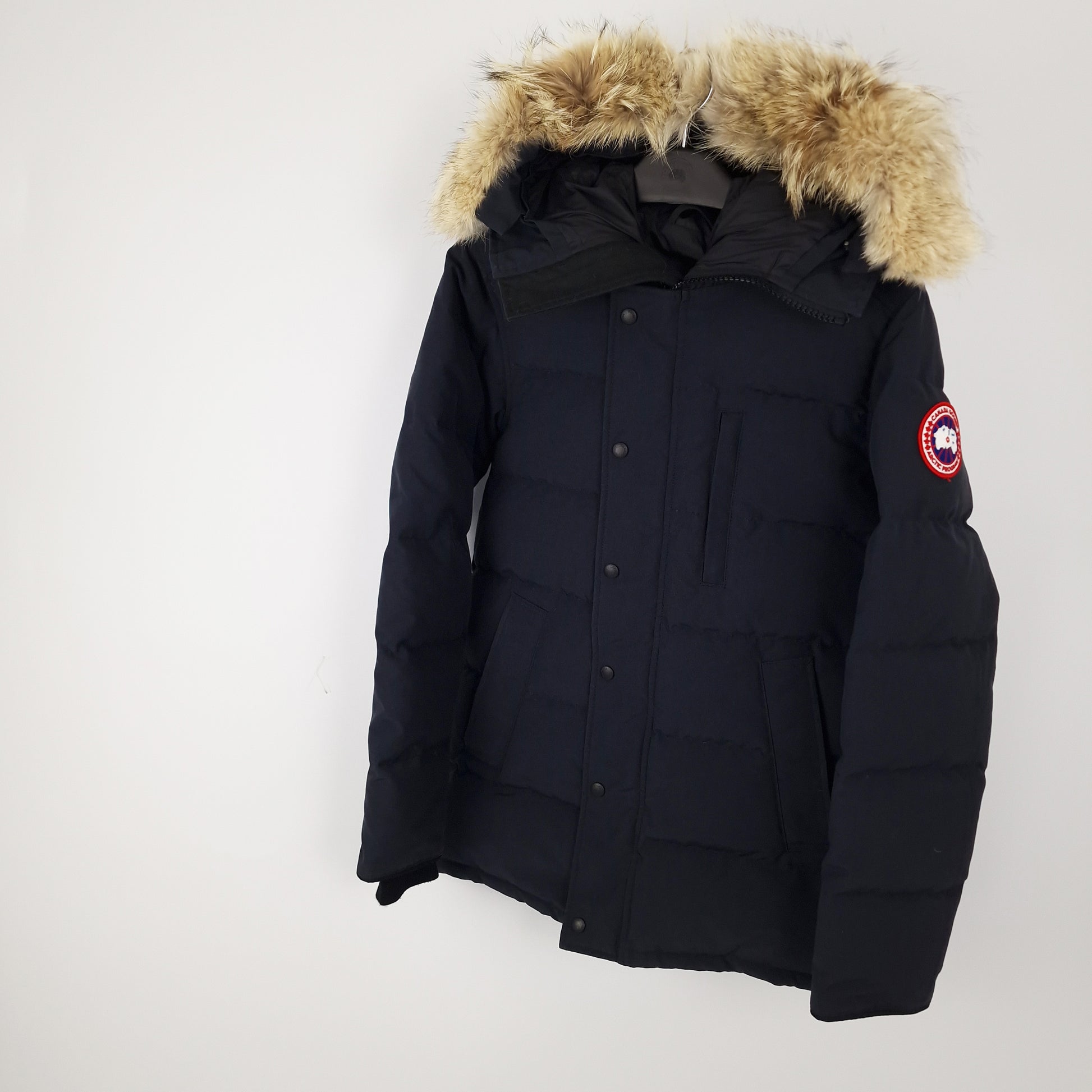 Professional product photo of Canada Goose Carson Parka in navy, men's luxury down-filled winter coat with fur hood, style 3805MA Small, full jacket view