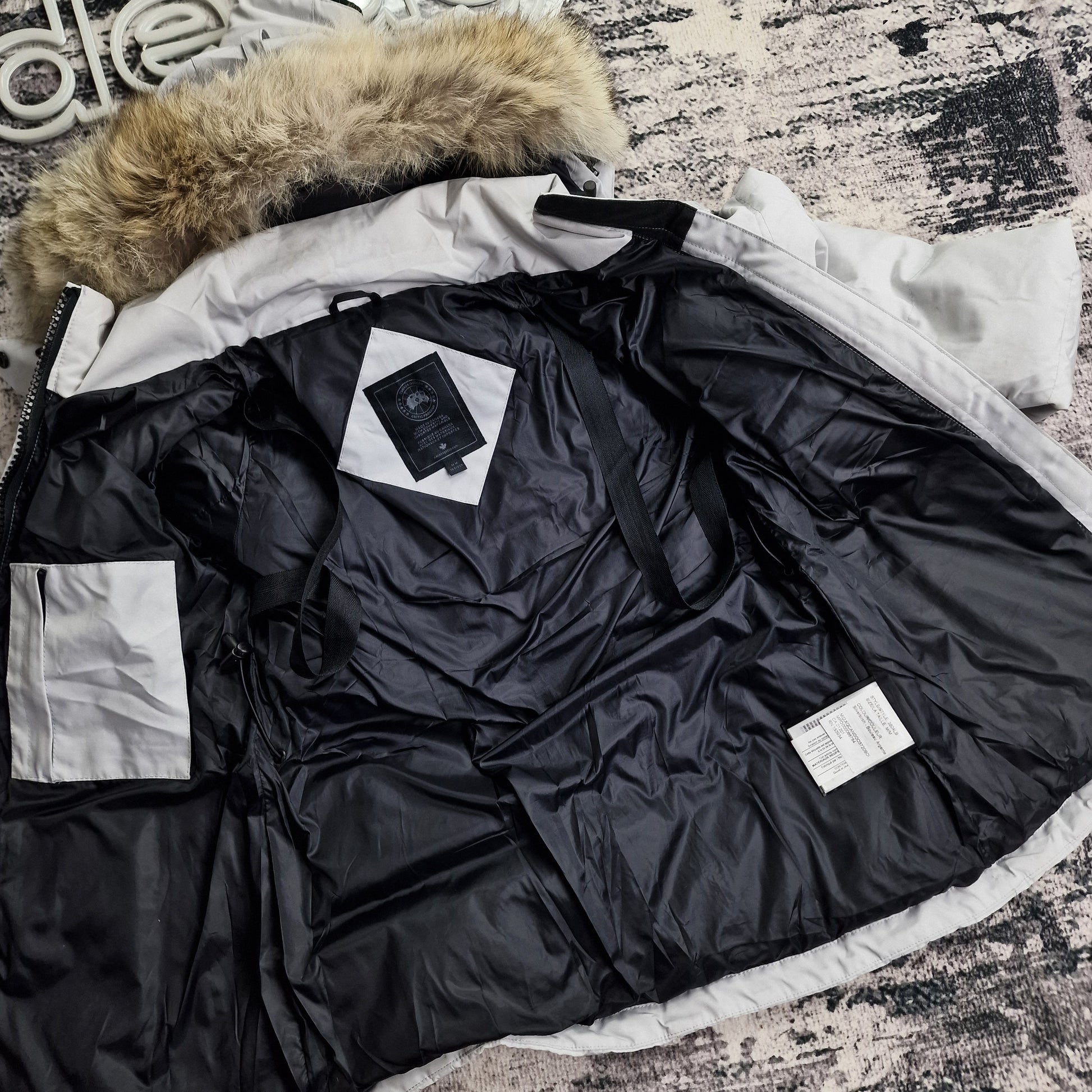 Close-up of authentic Canada Goose Arctic Program badge on Chelsea Parka Black Label 3804LB, Silverbirch colorway Medium, showing iconic logo patch detail on women's luxury winter jacket