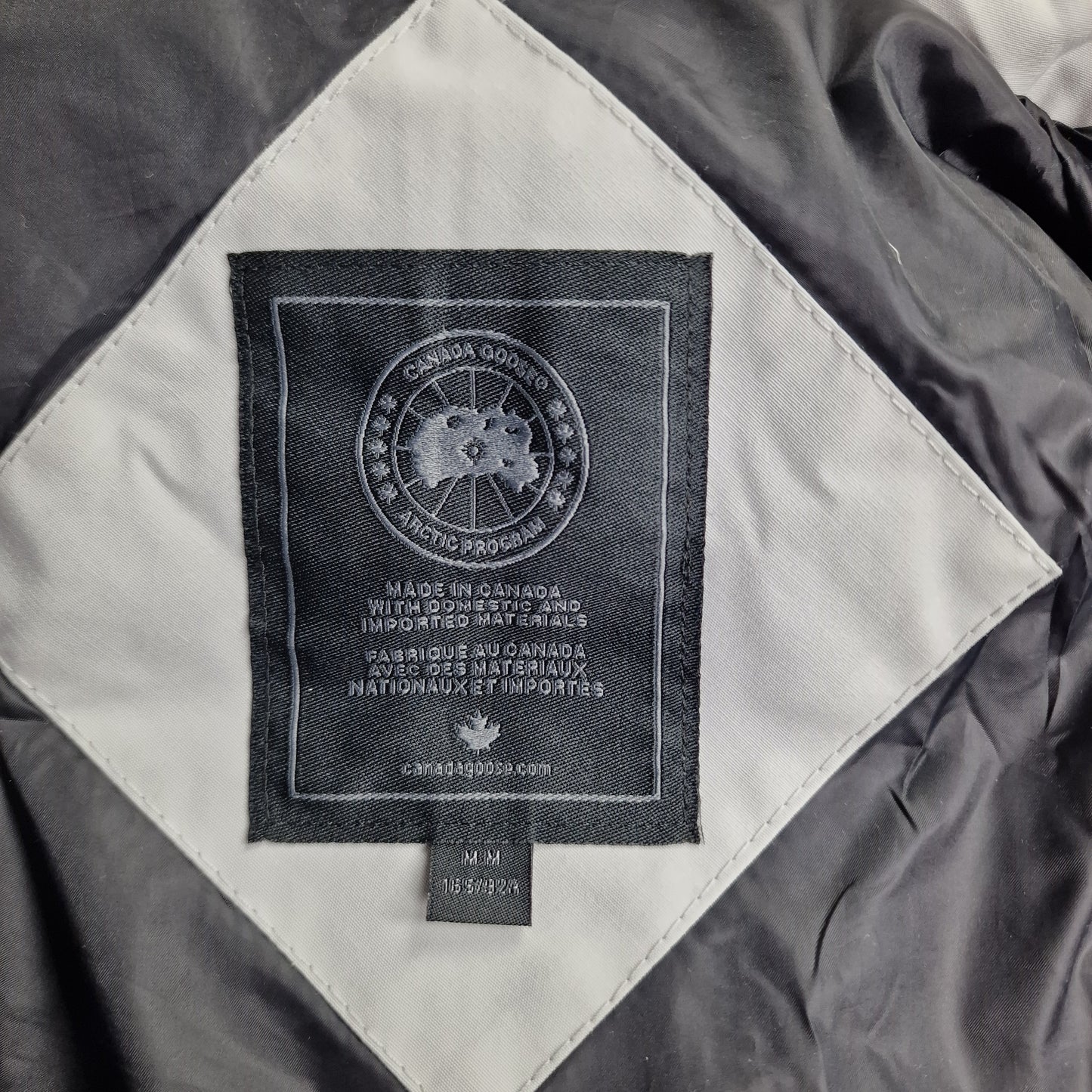 Close-up of Canada Goose necktag label inside Chelsea Parka Black Label 3804LB, showing authentic branding and size Medium details for women's Silverbirch winter jacket