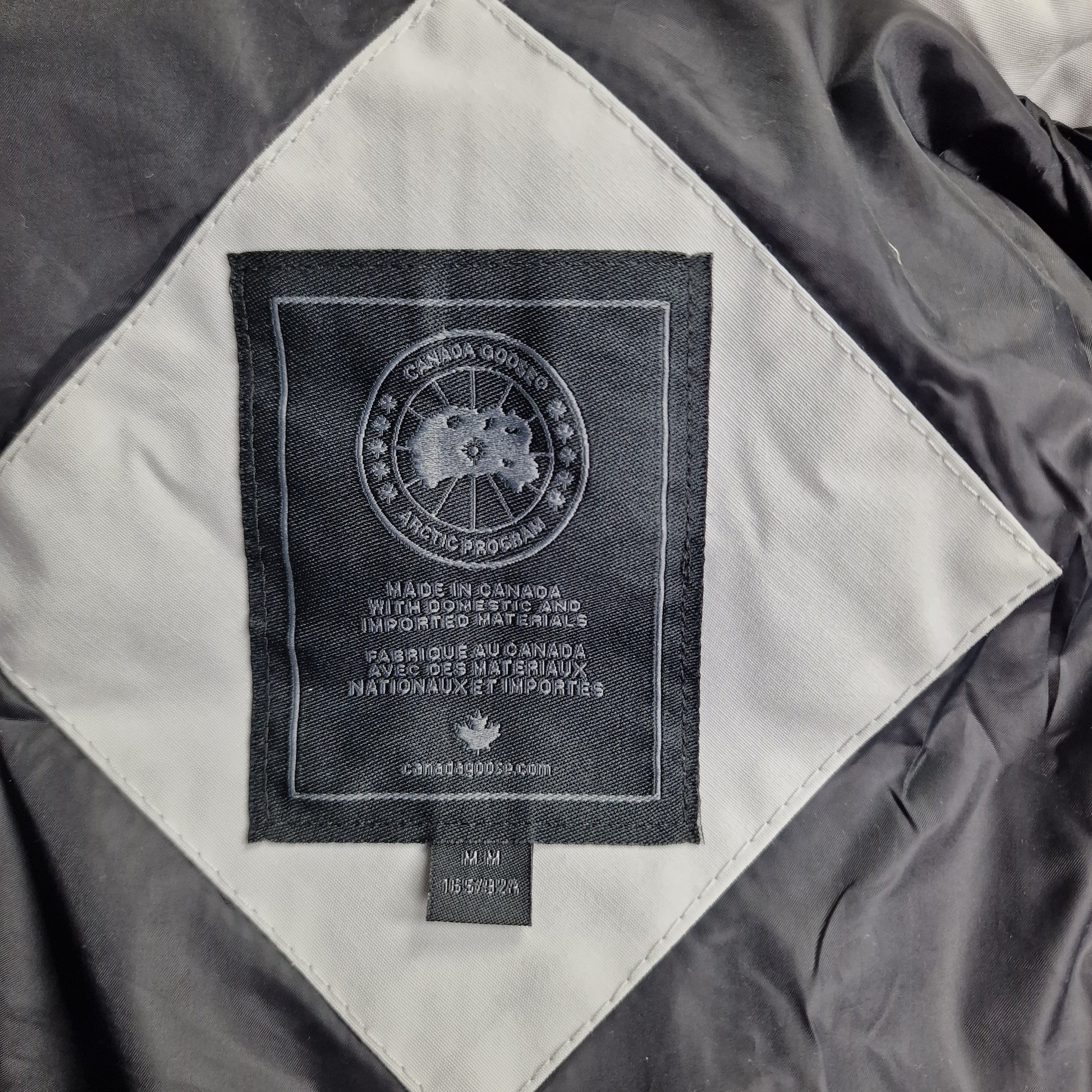 Close-up of Canada Goose necktag label inside Chelsea Parka Black Label 3804LB, showing authentic branding and size Medium details for women's Silverbirch winter jacket
