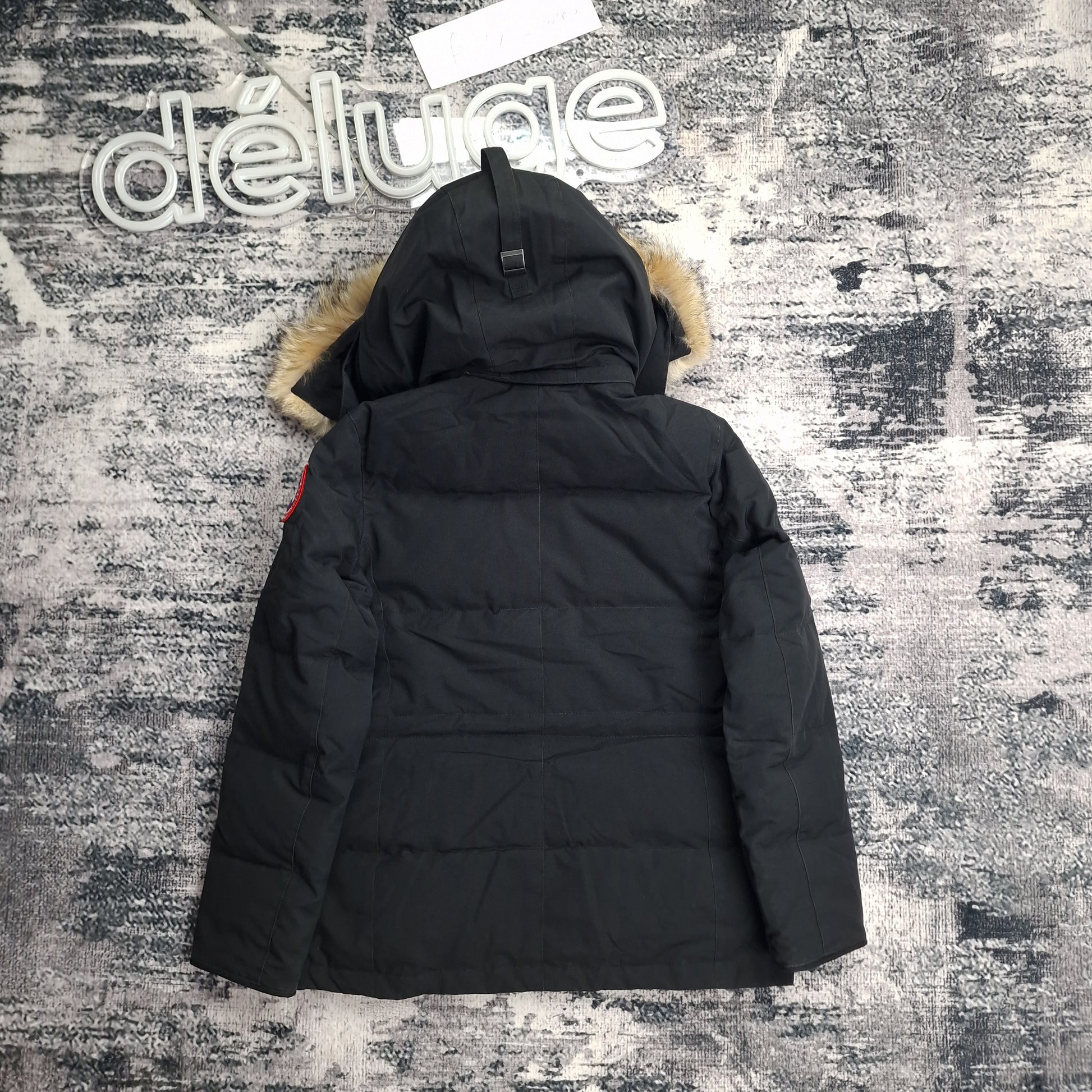 Back view of women's Canada Goose Chelsea Parka 3804LA Medium in black featuring Arctic Program patch, hip-length winter coat photographed on styled background