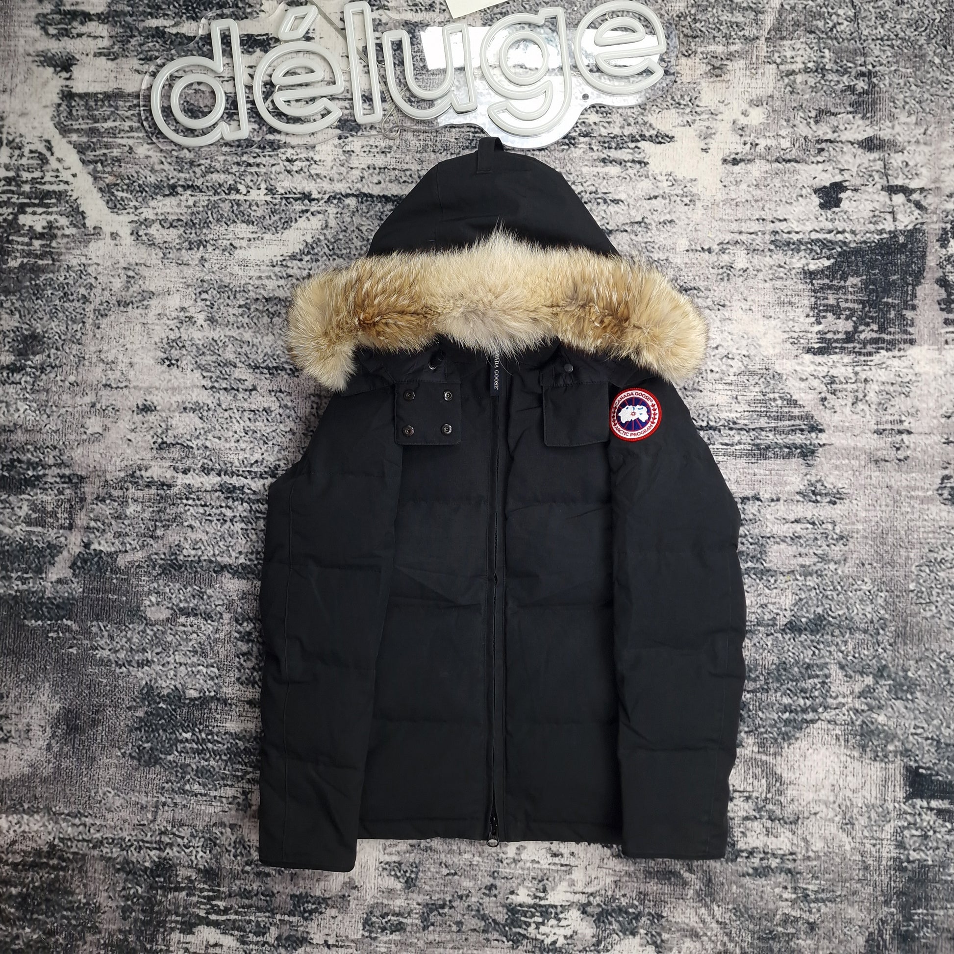 Front view of women's Canada Goose Chelsea Parka 3804LA Medium in black with coyote fur-trimmed hood, luxury winter coat photographed on styled background