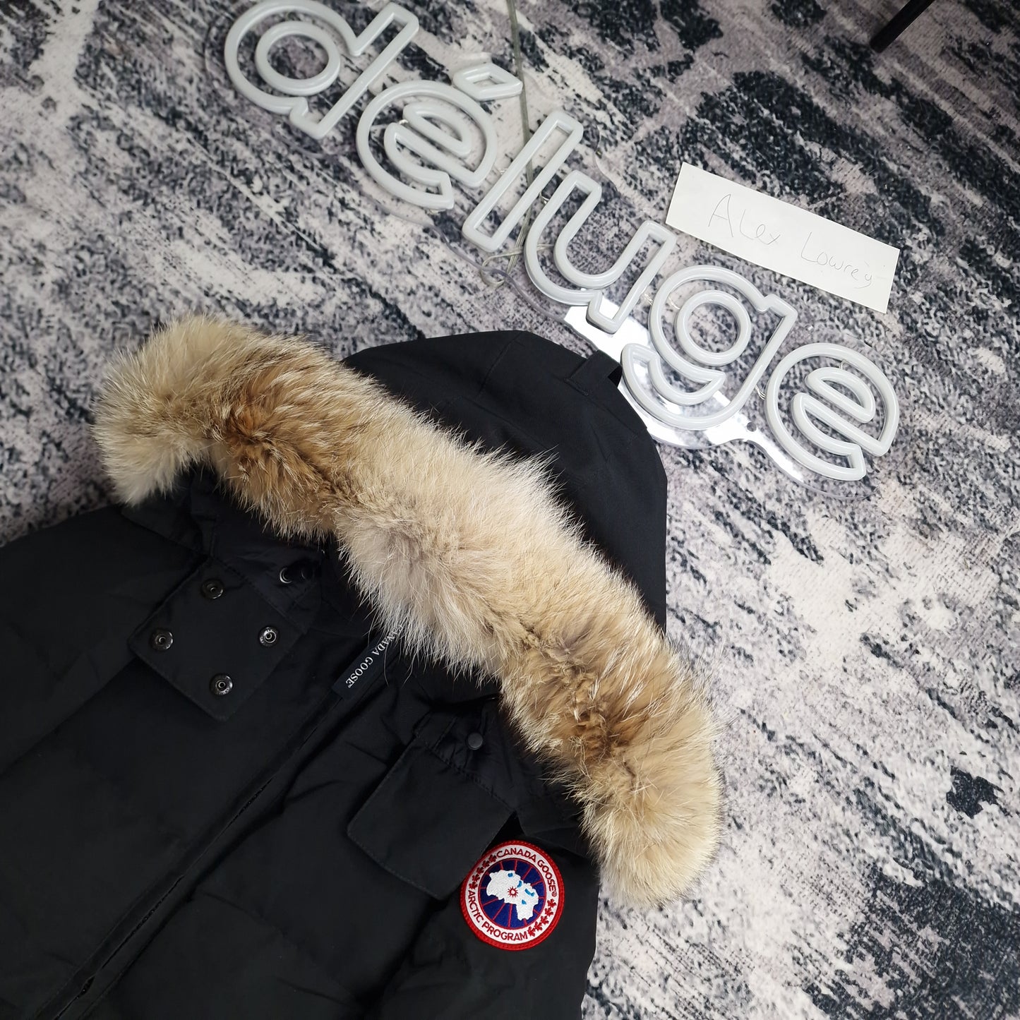 Close-up side view of Canada Goose Chelsea Parka showing authentic coyote fur hood trim and iconic Canada Goose Arctic Program badge, black colorway 3804LA Medium