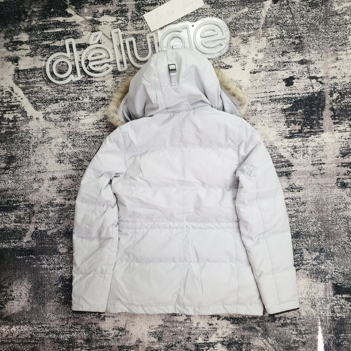 Back view of women's Canada Goose Chelsea Parka Black Label 3804LB Medium in Silverbirch featuring Arctic Program patch, hip-length winter coat photographed on styled background