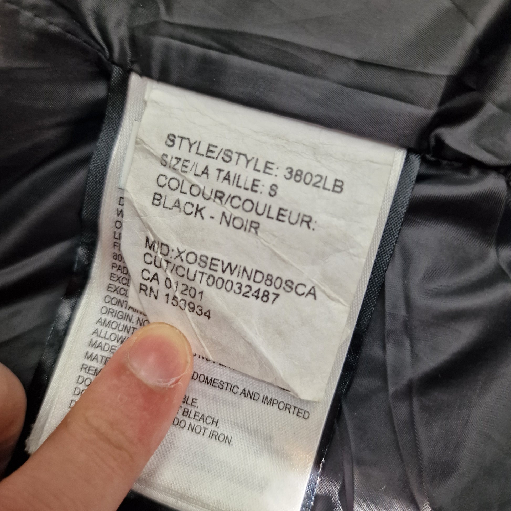 White care label washtag showing style code 3802LB, Black Label designation, and size Small information for authentic Canada Goose Shelburne Parka women's winter jacket