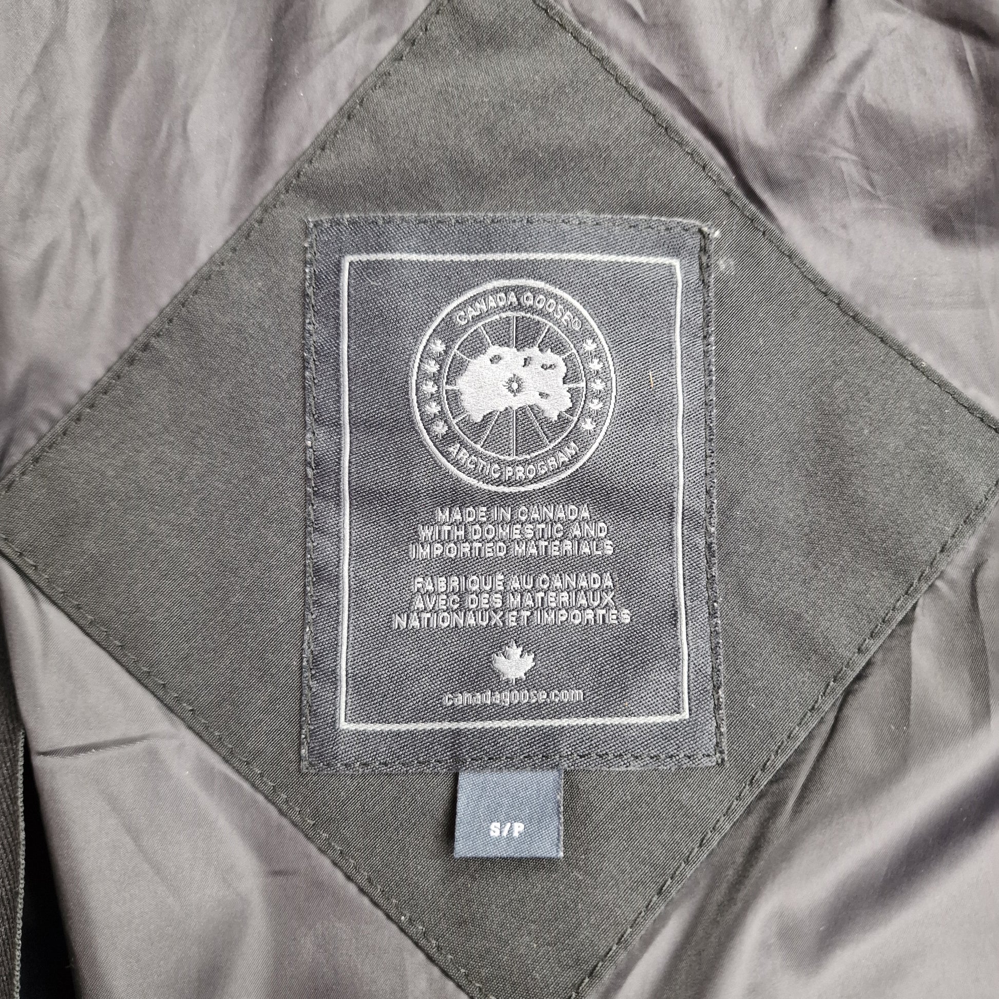 Close-up of Canada Goose necktag label inside Shelburne Parka Black Label 3802LB, showing authentic branding and size Small details for women's black winter jacket