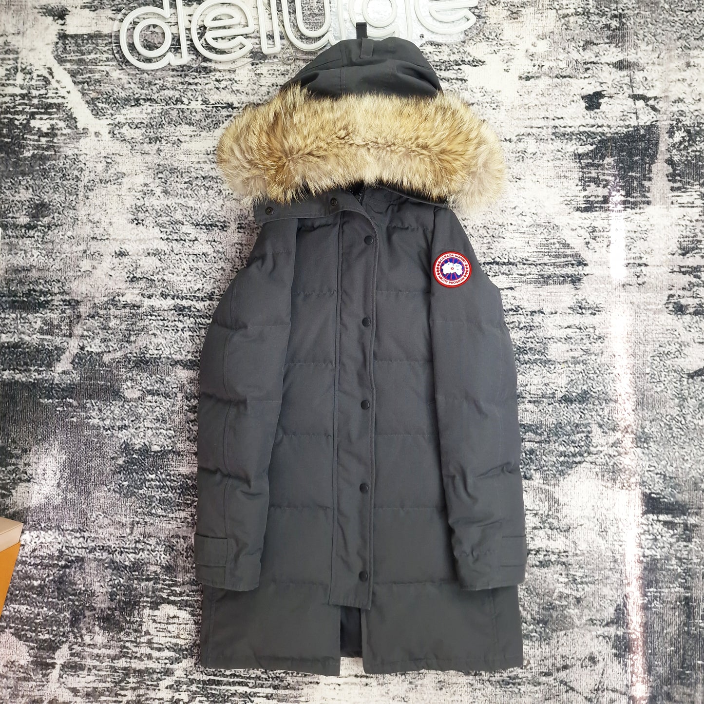 Front view of women's Canada Goose Mackenzie Parka Medium in Graphite grey with coyote fur hood, Shelburne Parka alternative luxury winter coat on styled background