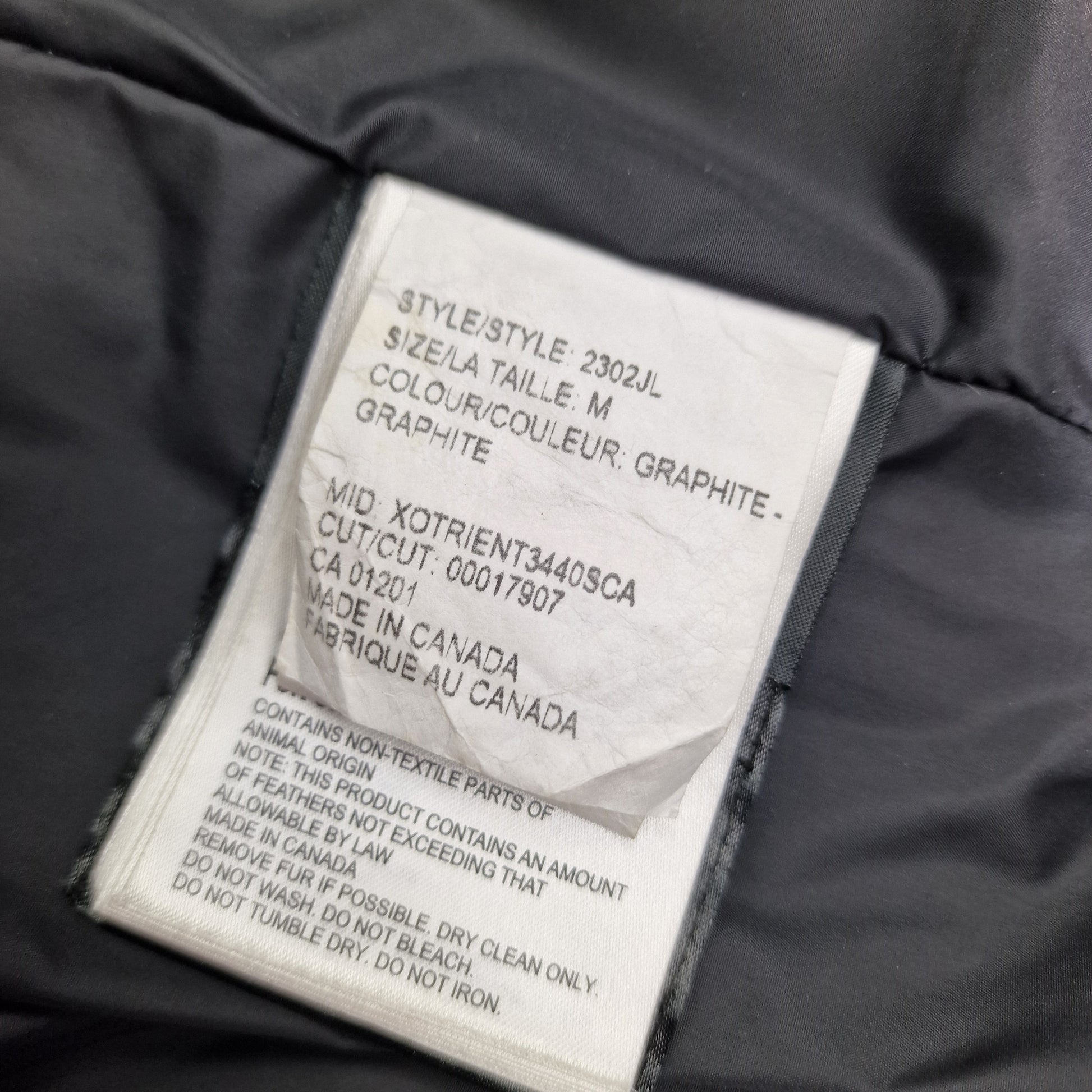 White care label showing Mackenzie Parka details, Graphite grey Medium, authentic Canada Goose women's winter coat similar to Shelburne Parka style