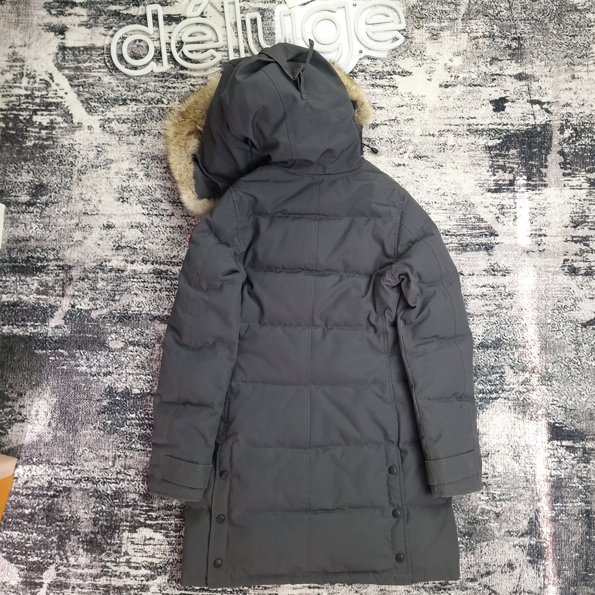 Close-up side view of Canada Goose Mackenzie Parka showing authentic coyote fur trim and Arctic Program badge, Graphite grey colorway Medium, similar to Shelburne Parka design