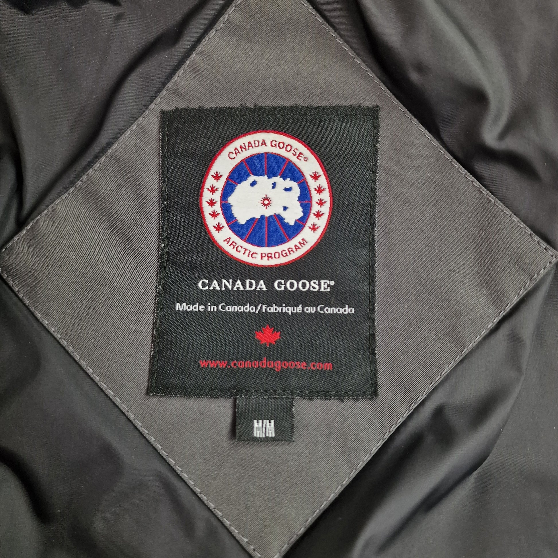 Close-up of Canada Goose necktag inside Mackenzie Parka, authentic branding for Medium Graphite grey women's winter jacket, Shelburne Parka alternative