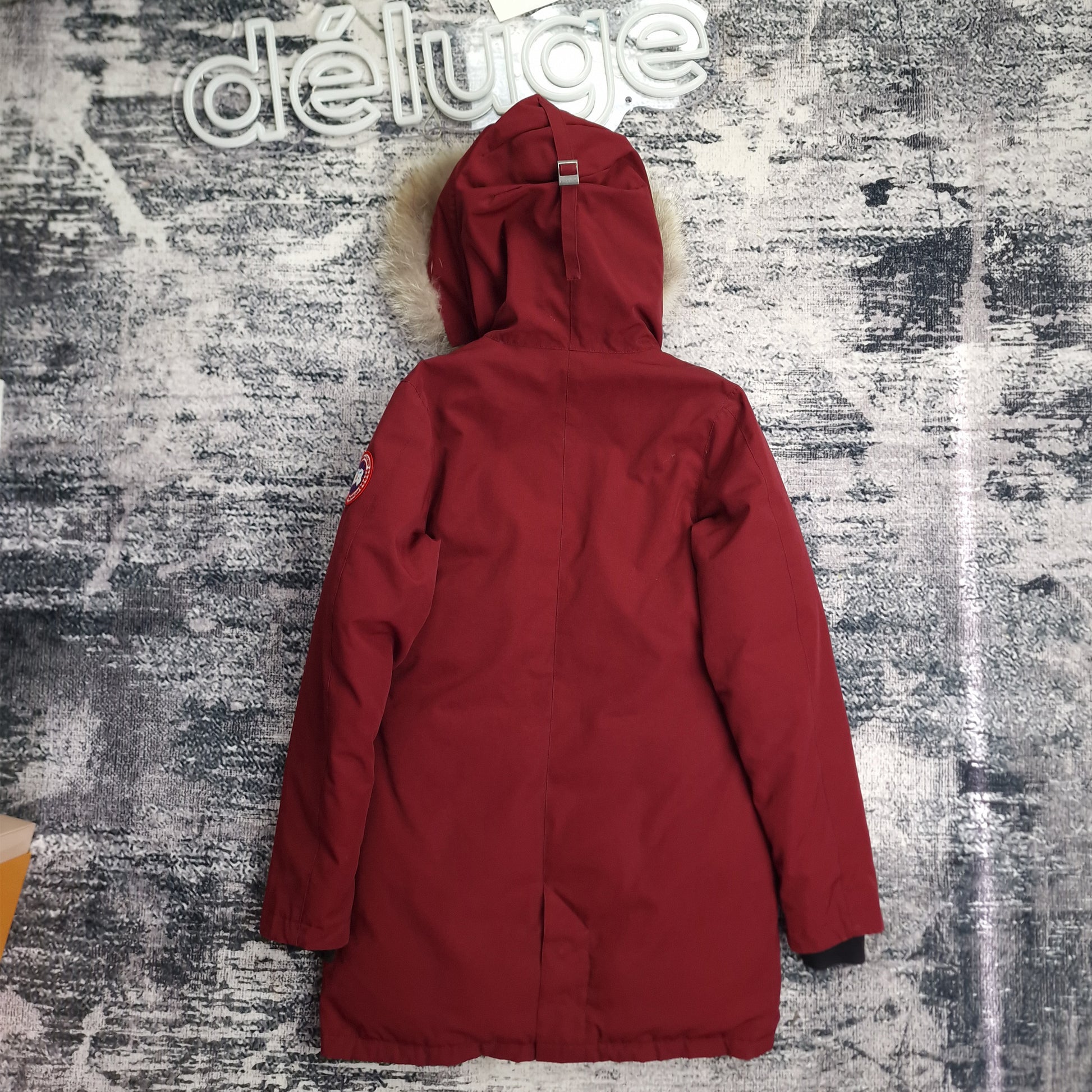 Back view of women's Canada Goose Victoria Parka size Small in Niagara Grape burgundy featuring Arctic Program patch, slim-fit luxury winter coat on styled background
