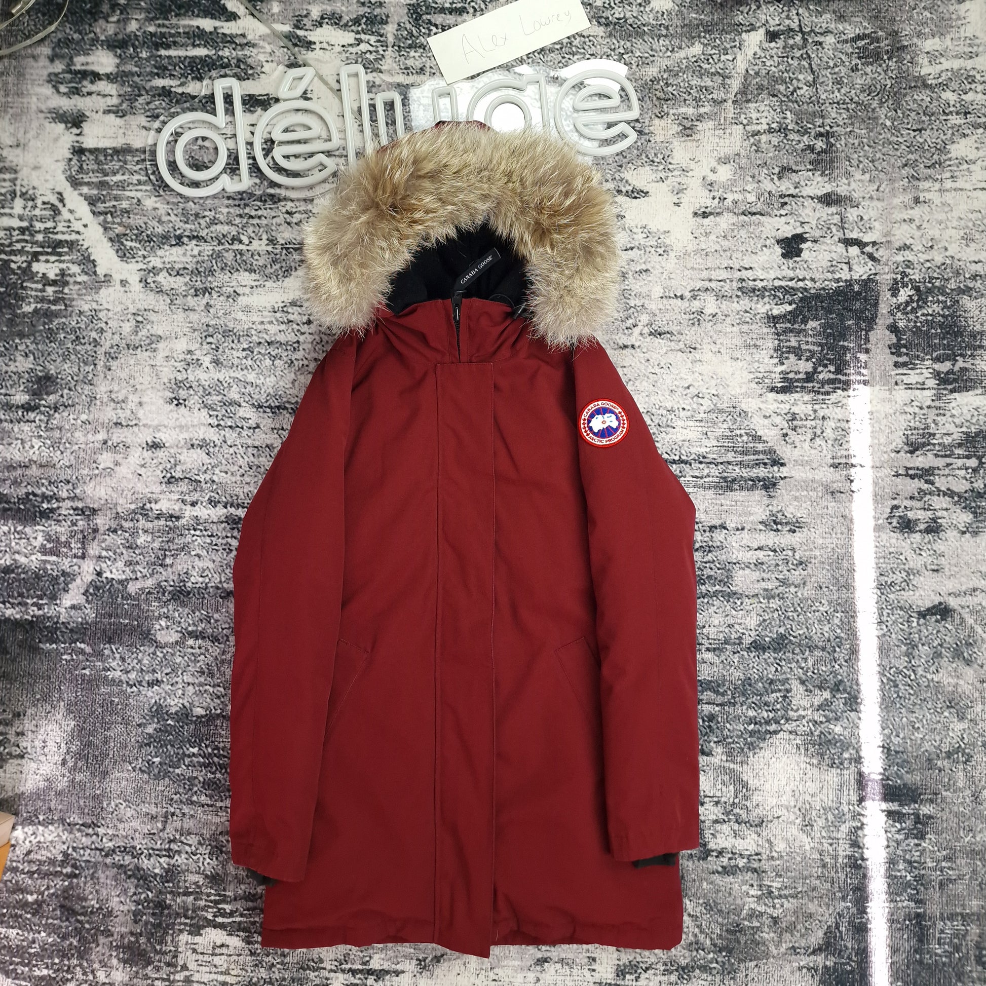 Front view of women's Canada Goose Victoria Parka size Small in Niagara Grape burgundy with coyote fur-trimmed hood, luxury winter coat photographed on styled background