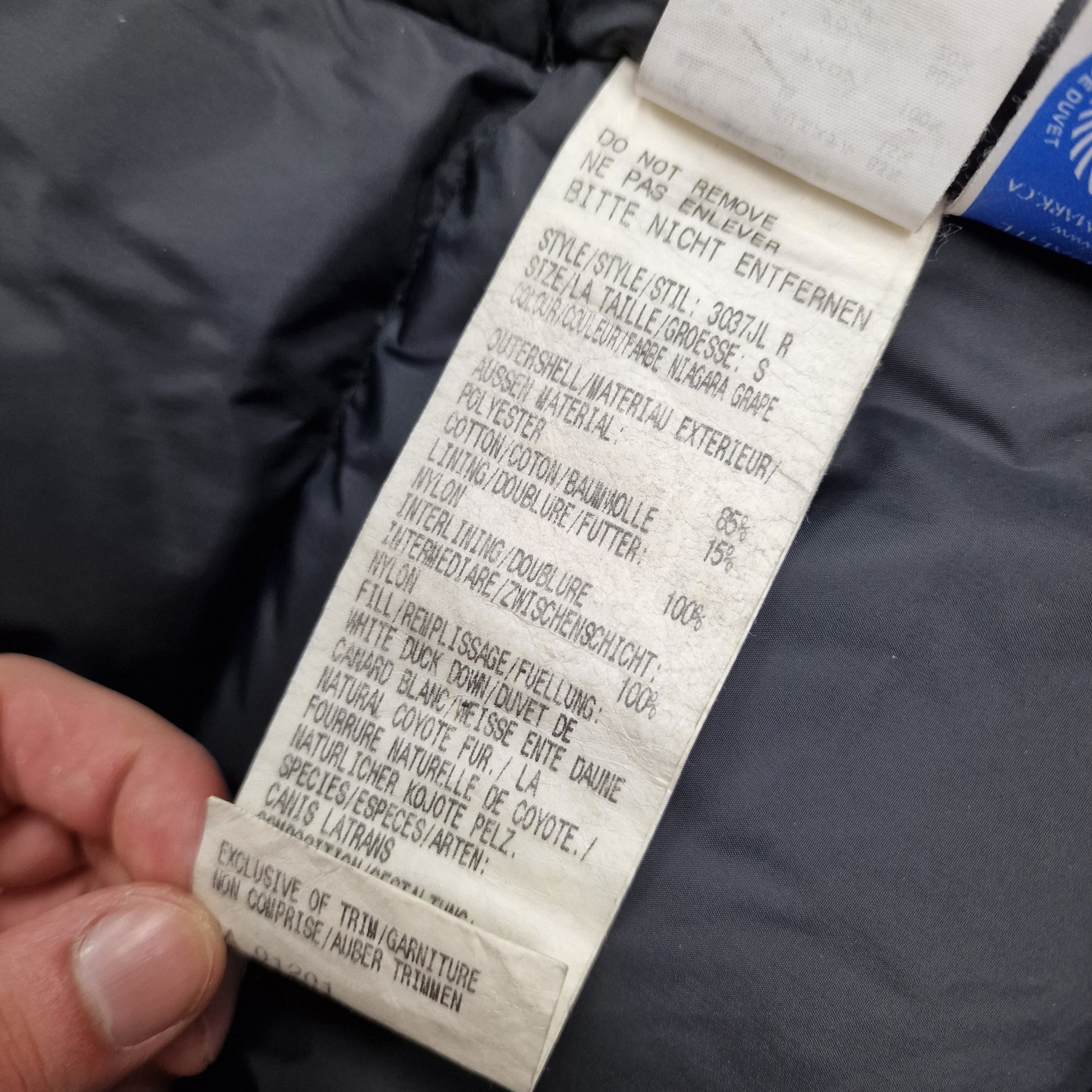 White care label washtag showing Victoria Parka style code, Niagara Grape color designation, and size Small information for authentic Canada Goose women's winter jacket