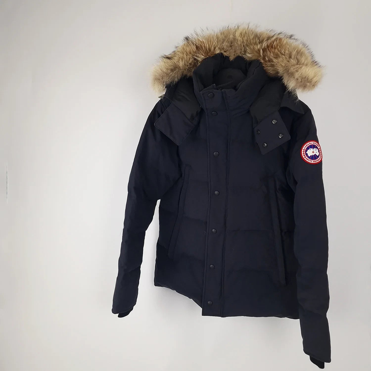Professional product photo of Canada Goose Wyndham Parka in navy, men's luxury down-filled winter coat with fur hood, style 3808MA Large, full jacket view