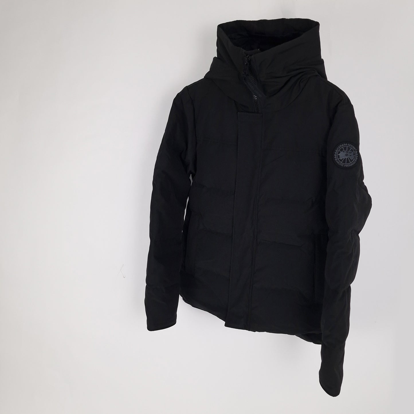 Three-quarter angle of authentic Canada Goose Macmillan Black Label jacket 2080MB in black, men's size small, displaying sleek urban silhouette and premium materials