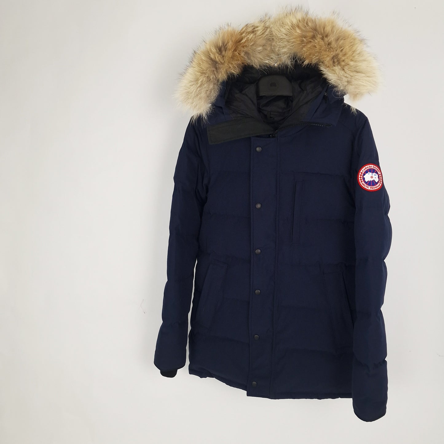 Angled view of Canada Goose Carson Parka 3805MA men's medium displaying coyote fur hood and Heritage Admiral Blue thigh-length design