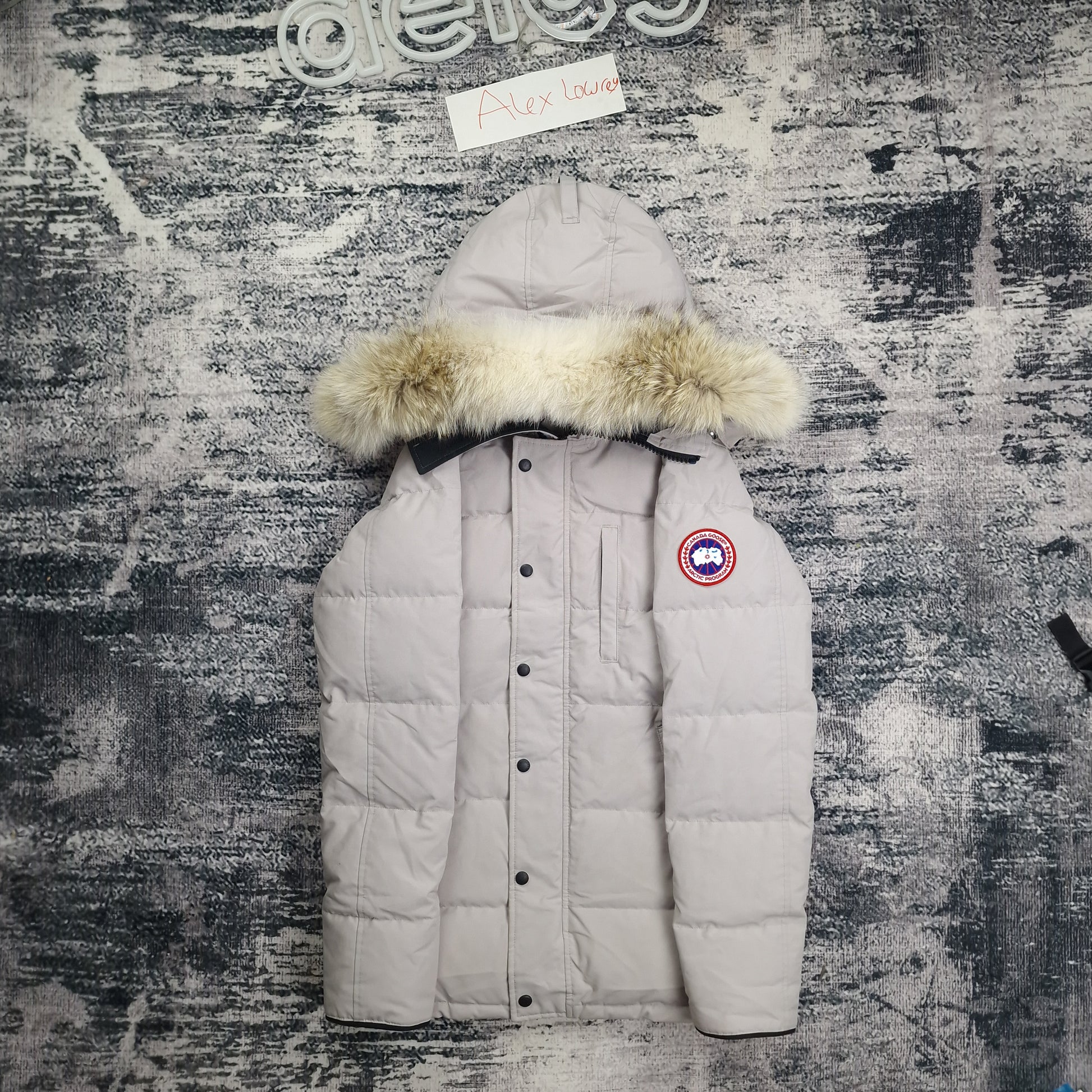 Front flat lay of Canada Goose Carson Parka 3805M men's small featuring coyote fur hood, chest pockets, and Arctic badge