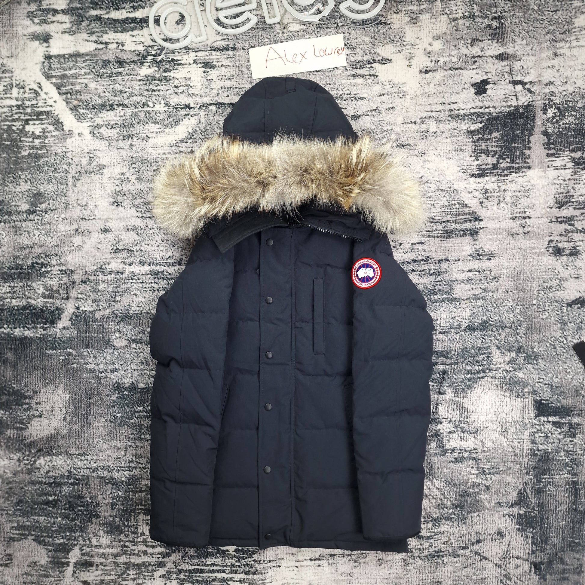 Front flat lay of Canada Goose Carson Parka 3805MA men's small featuring coyote fur hood trim and Arctic Program badge