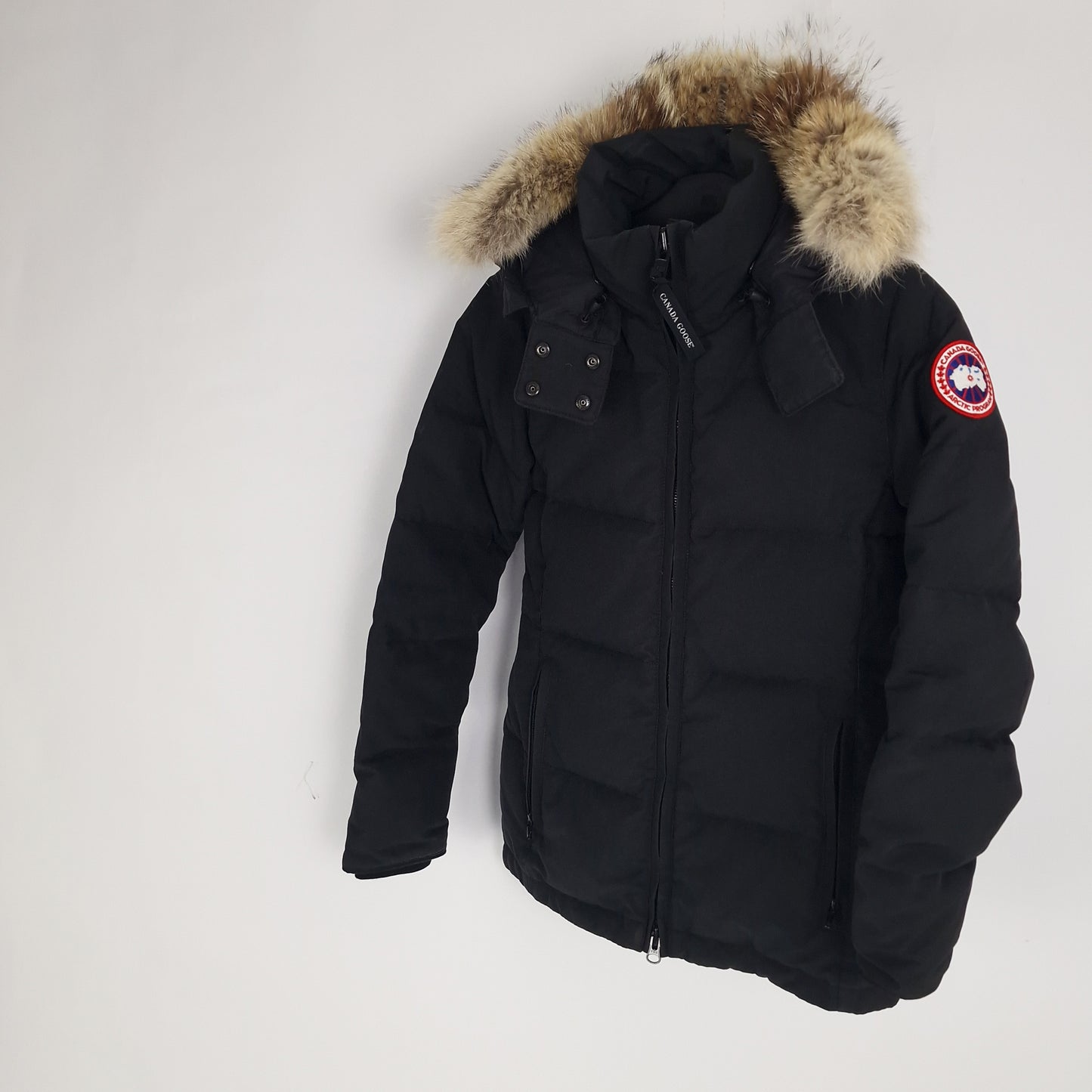 Angled detail shot of black Canada Goose Chelsea Parka 3804L women's size small displaying fur trim, side pockets, and tailored silhouette