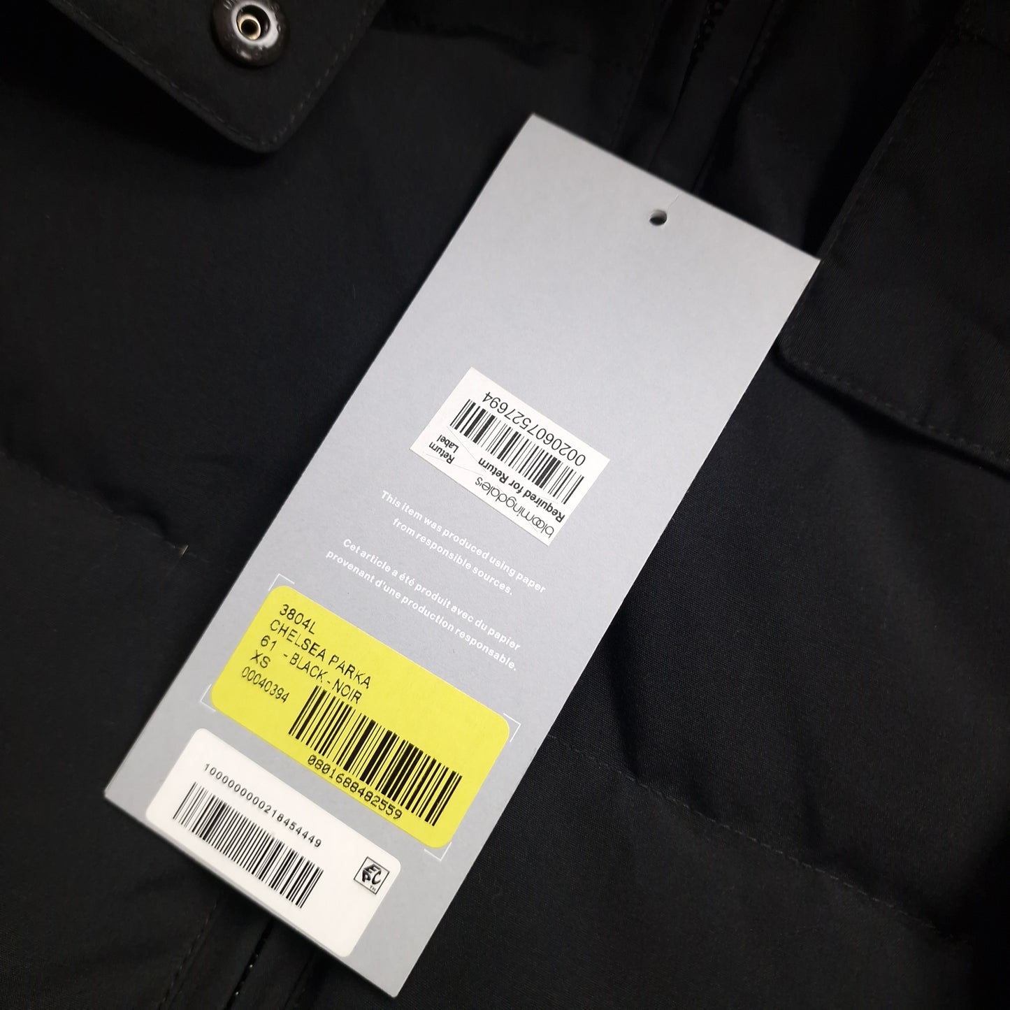 Canada Goose Chelsea Parka Black XS Women's authenticity tag detail. Verify genuine product with hologram and serial number. Original luxury winter coat.