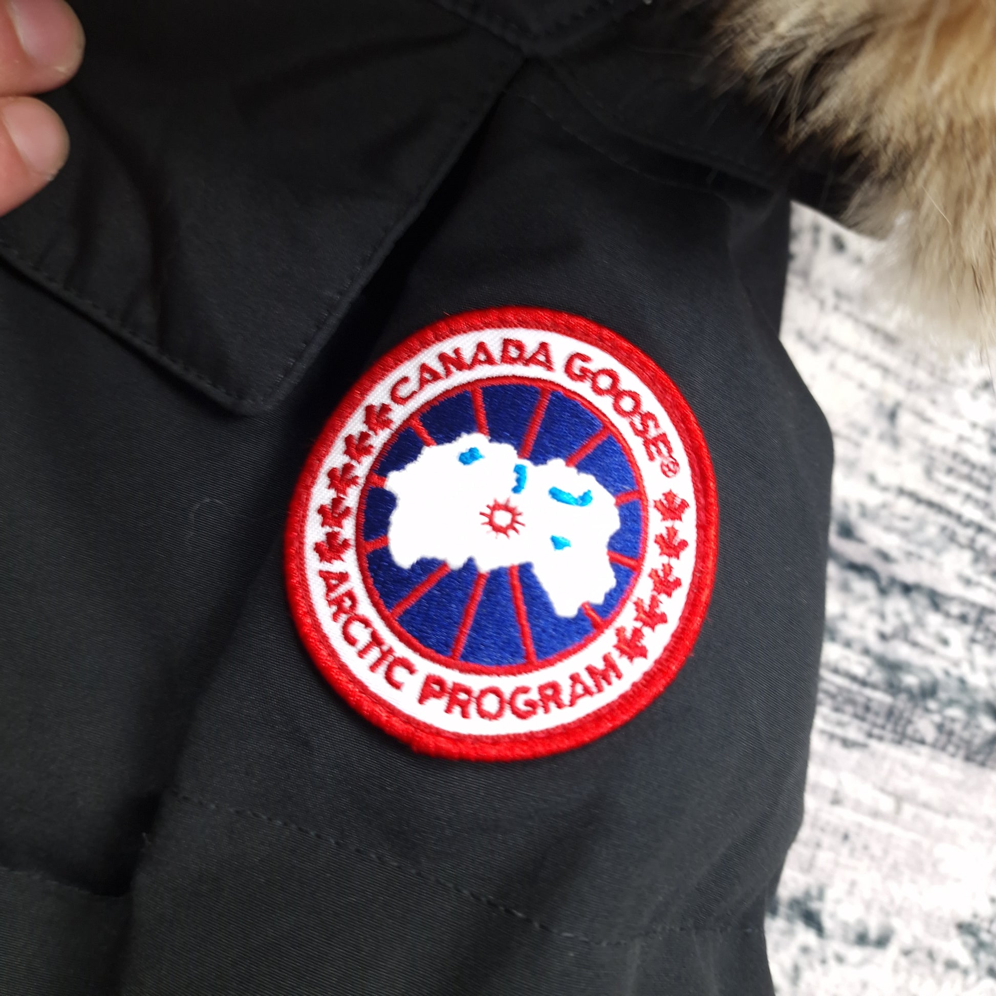 Canada Goose Chelsea Parka Black XS Women's authentic Arctic Program badge close-up. Verify genuine quality with iconic sleeve patch. Shop original luxury.