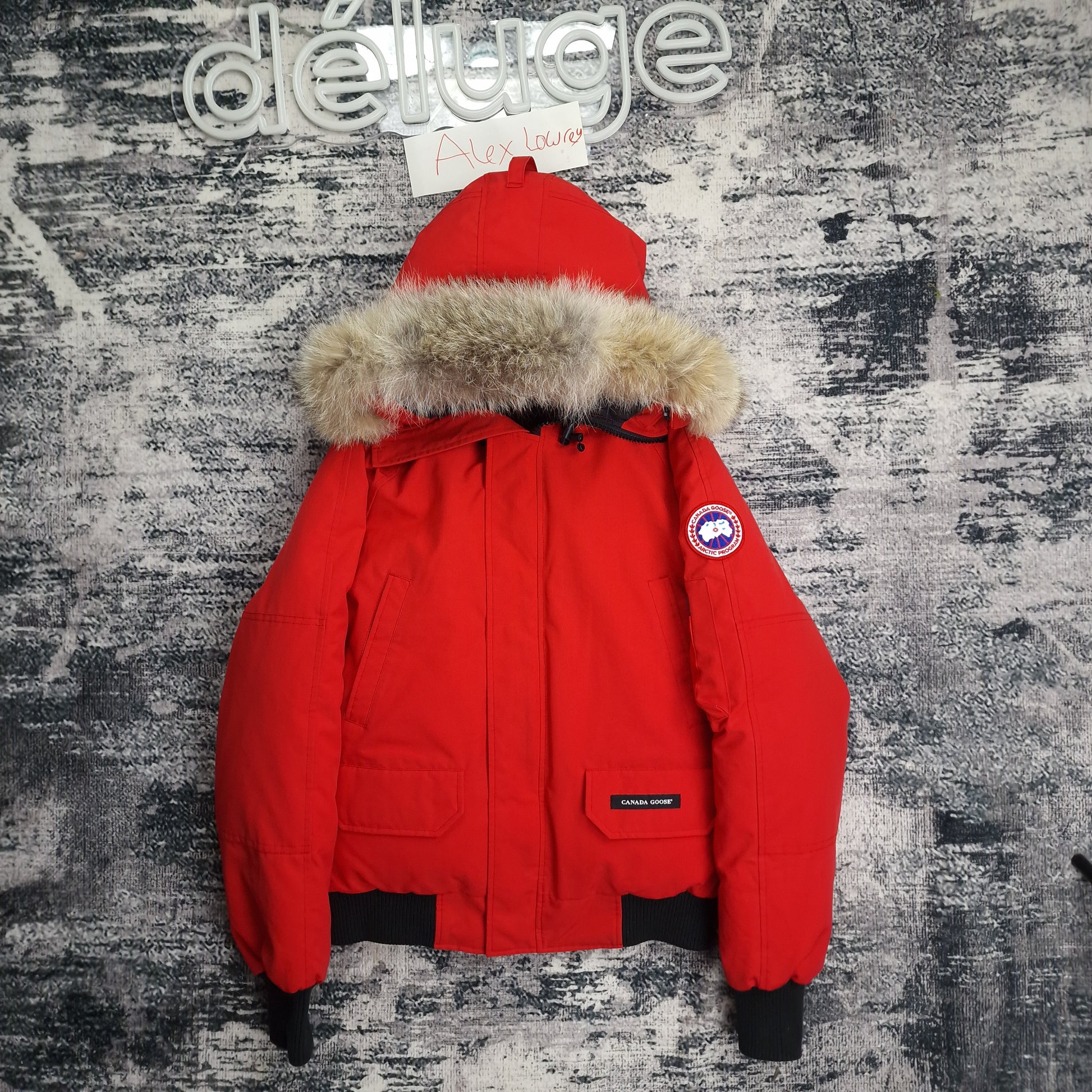 Front flat lay of authentic red Canada Goose Chilliwack bomber jacket size small with coyote fur hood and Arctic Program badge