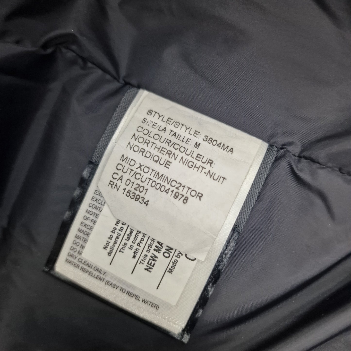 Style tag detail of Canada Goose Macmillan Parka 3804MA showing Northern Night color and size medium specifications
