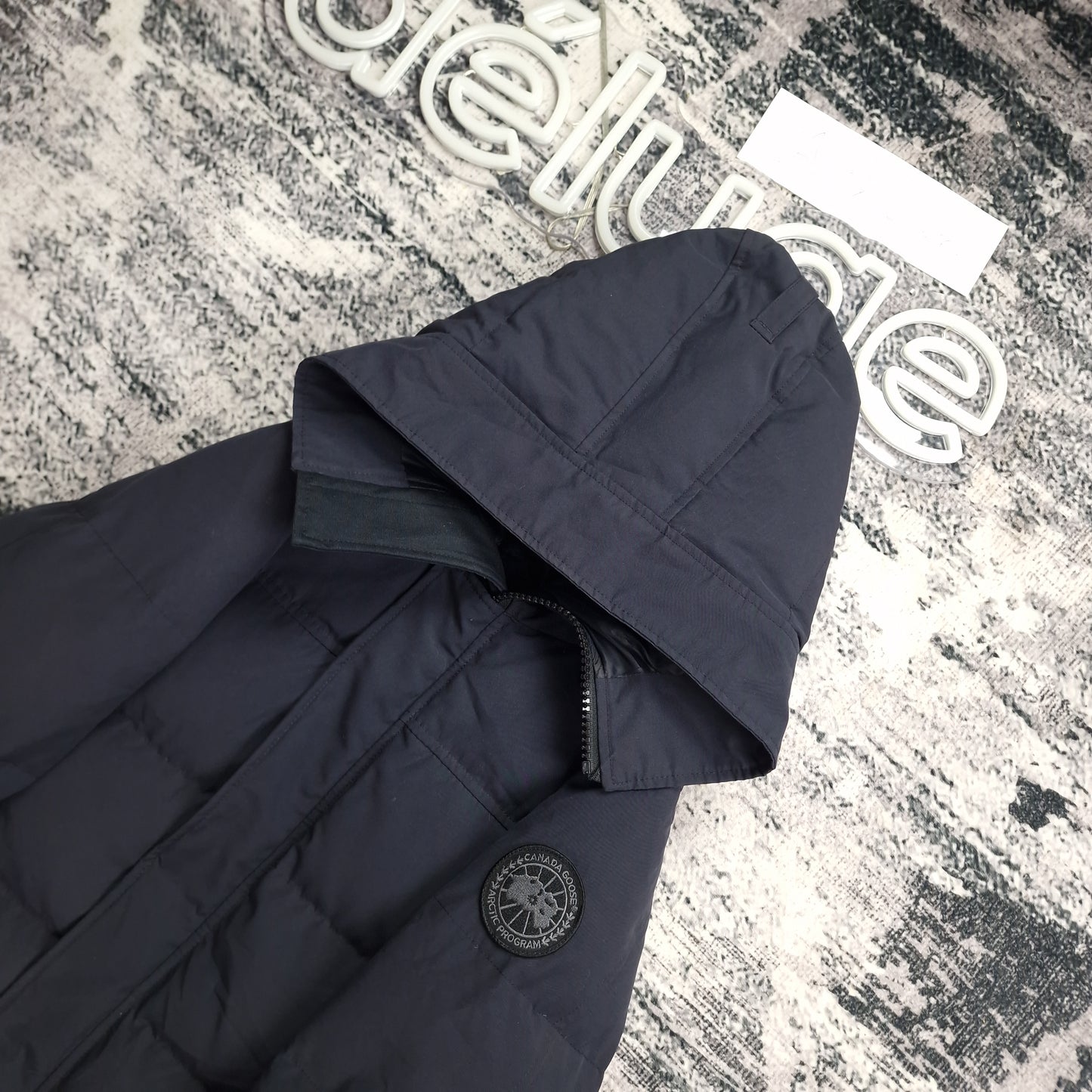 Canada Goose Macmillan Black Label Navy XS side angle at DelugeStore. Shows exclusive black Arctic badge and coyote fur-trimmed hood detail. Men's luxury down-filled winter parka. Shop authentic now.